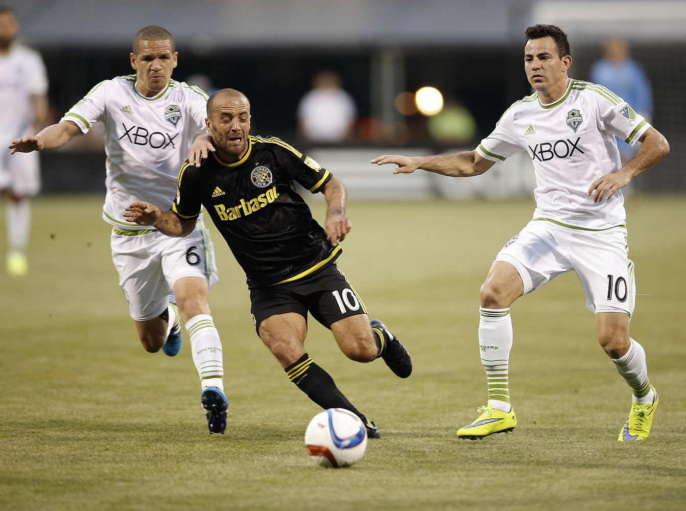 Columbus Crew forward Federico Higuain (10) battles for the ball against Seattle Sounders midfielders Osvaldo Alonso (6) and and Marco Pappa (10) during the first half of an MLS soccer game in Columbus, Ohio, on Saturday, May 9, 2015.