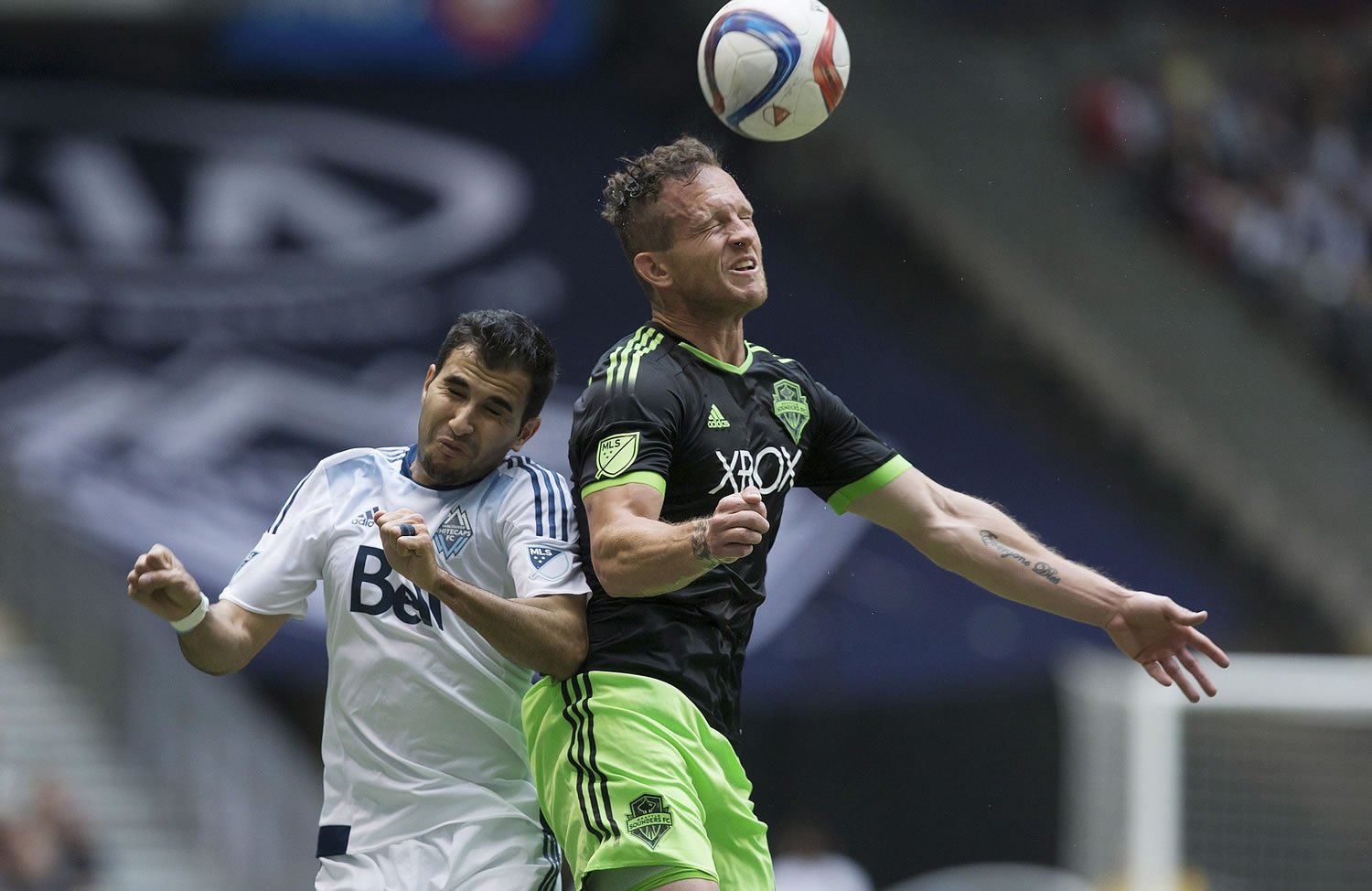 Seattle Sounders' Chad Barrett, right, out-jumps Vancouver Whitecaps' Steven Beitashour to get his head on the ball during the first half in Vancouver, British Columbia, on Saturday, May 16, 2015.