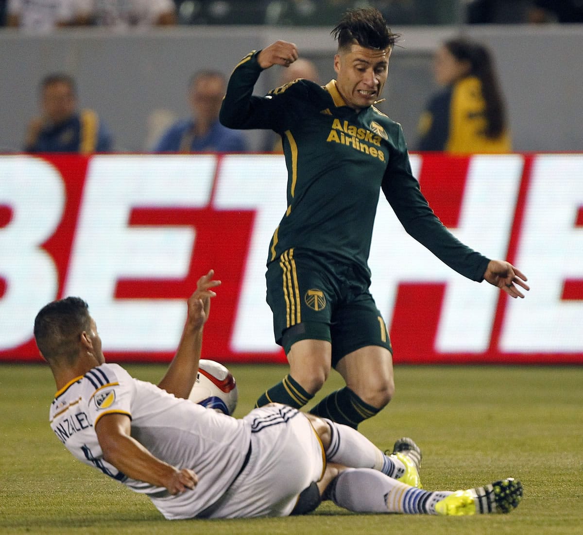 Los Angeles Galaxy defender Omar Gonzalez, left, tackles the ball away from Portland Timbers defender Jorge Villafana during the first half Wednesday.