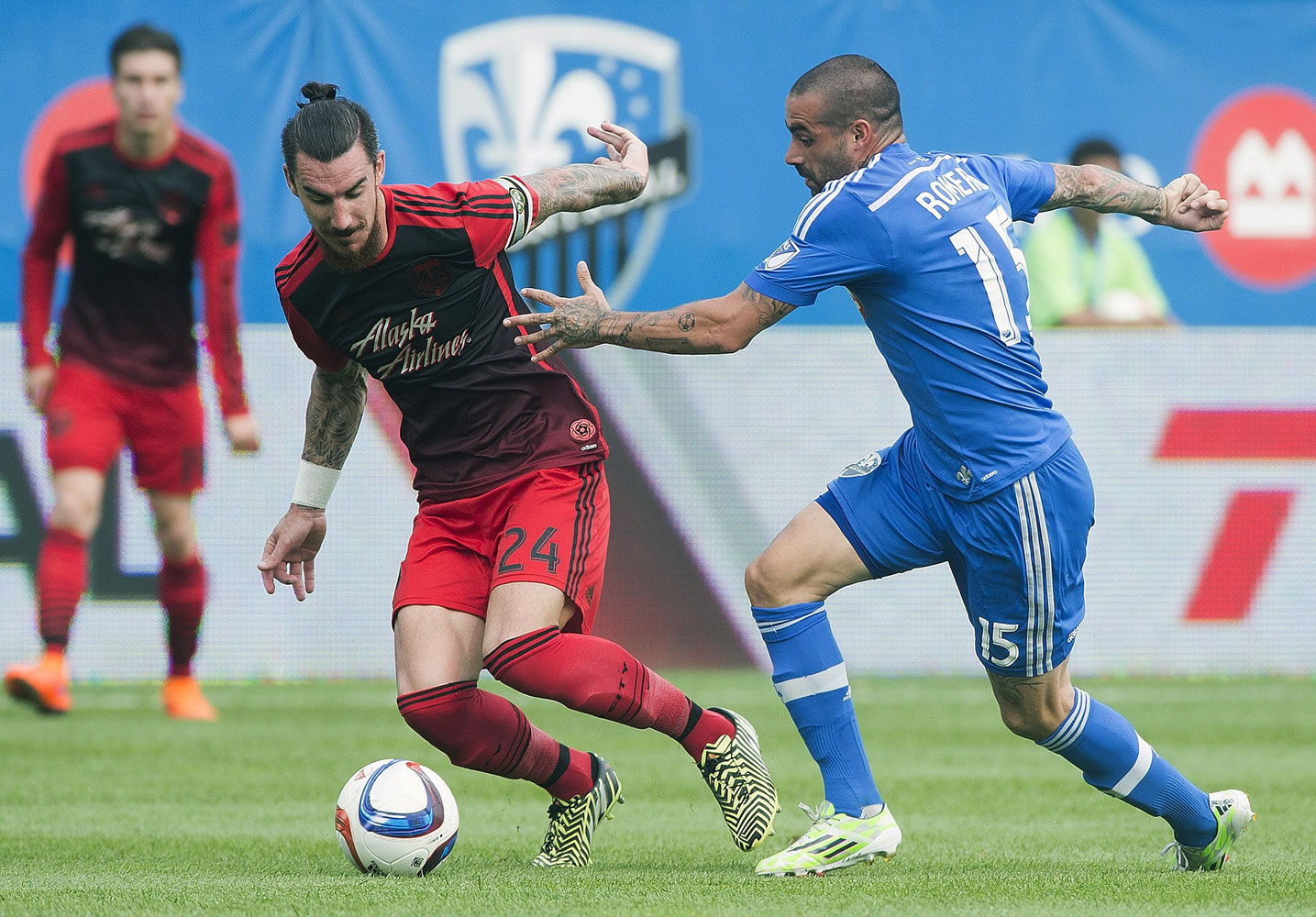 Montreal Impact's Andres Romero, right, challenges Portland Timbers' Liam Ridgewell during the first half of a soccer game, Saturday, May 9, 2015 in Montreal.