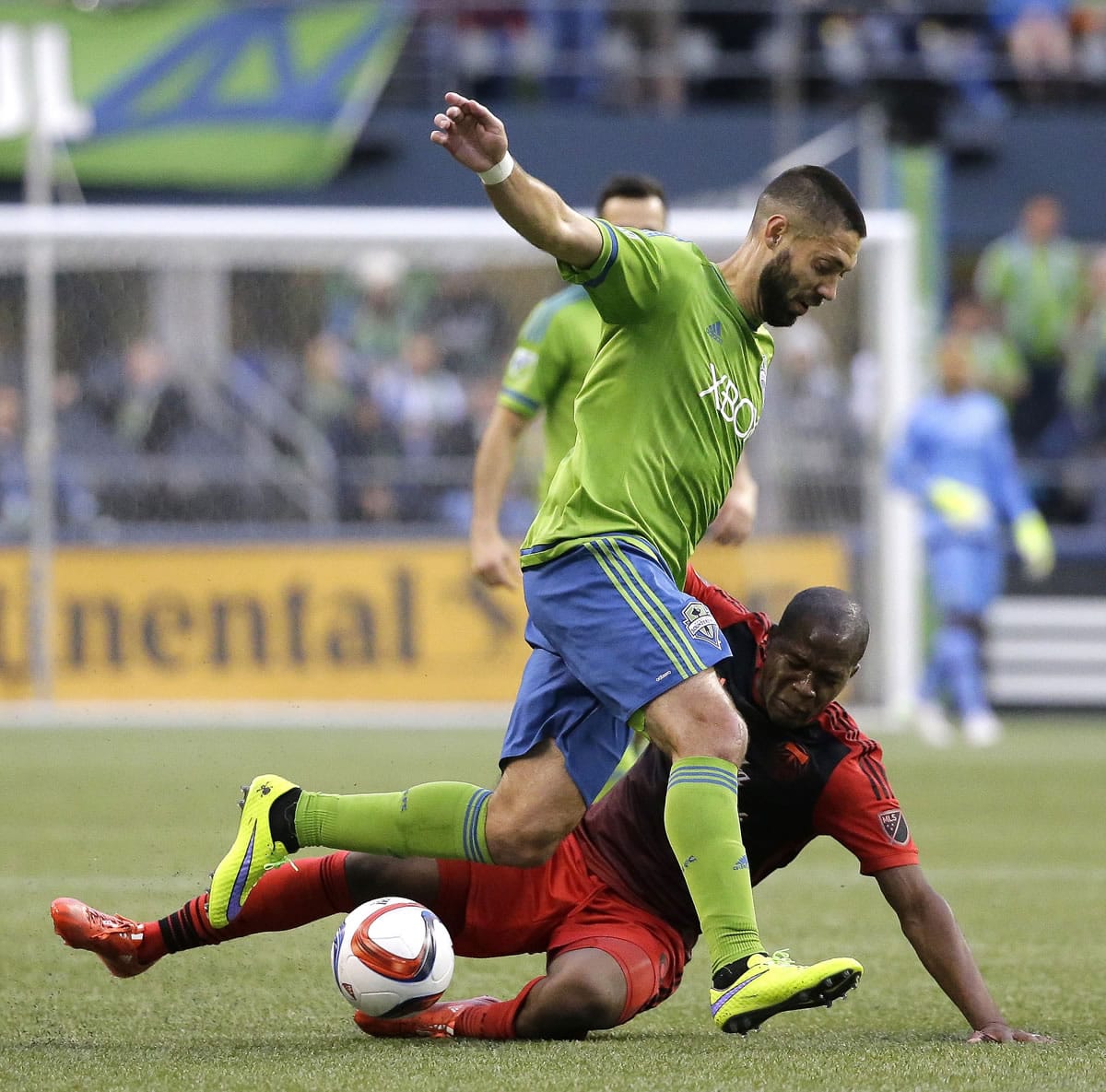 Seattle Sounders' Clint Dempsey runs with the ball as Portland Timbers' Darlington Nagbe goes down in the first half of an MLS soccer match, Sunday, April 26, 2015, in Seattle.
