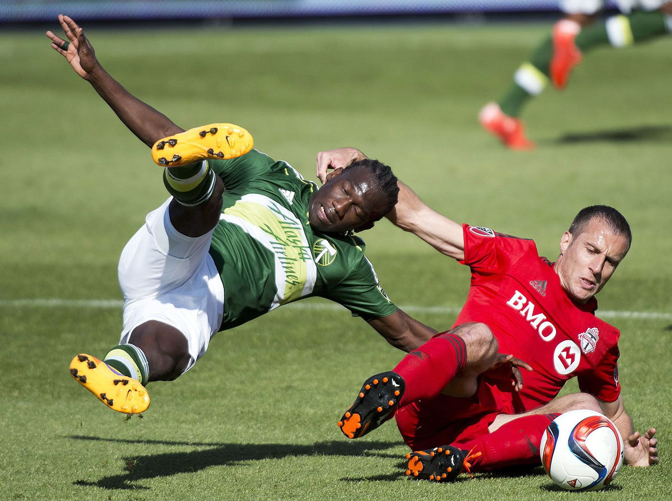 Toronto FC midfielder Benoit Cheyrou, right, battles for the ball against Portland Timbers midfielder Diego Chara during the first half in Toronto on Saturday, May 23, 2015.