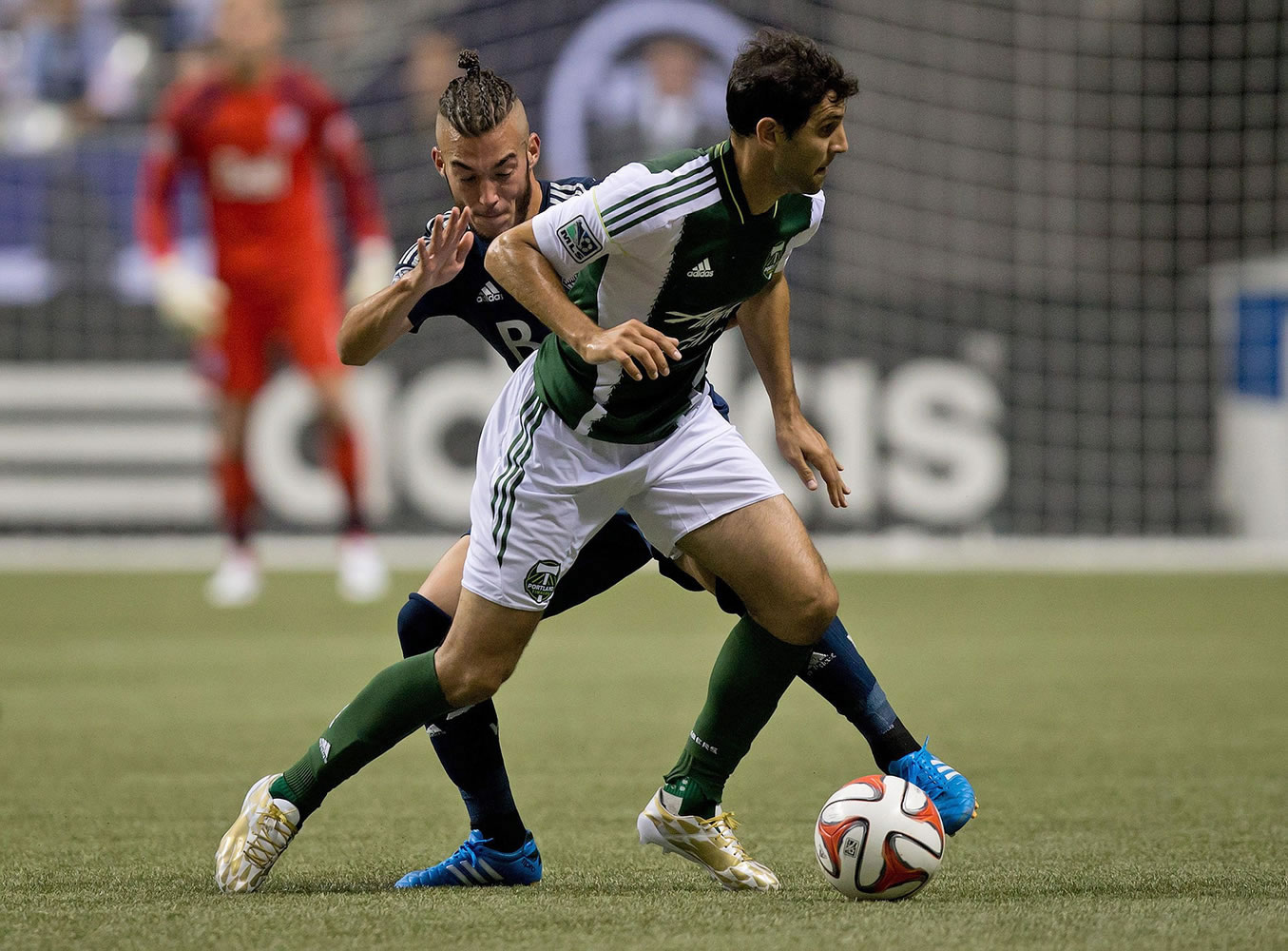 Portland Timbers' Diego Valeri, front, of Argentina, controls the ball as Vancouver Whitecaps' Russell Teibert defends during the first half of an MLS soccer game in Vancouver, British Columbia, on Saturday, Aug. 30, 2014.