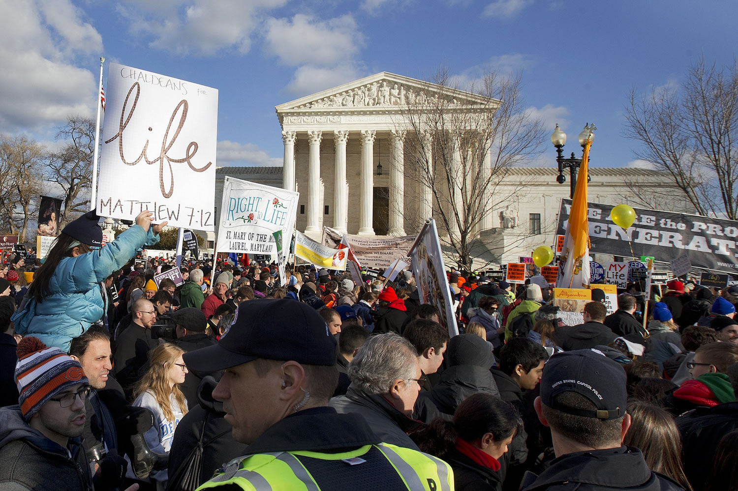 Anti-abortion demonstrators march past the Supreme Court in Washington, Thursday, Jan. 22, 2015, during the annual March for Life. Thousands of anti-abortion demonstrators are gathering in Washington for an annual march to protest the Supreme Court's landmark 1973 decision that declared a constitutional right to abortion.