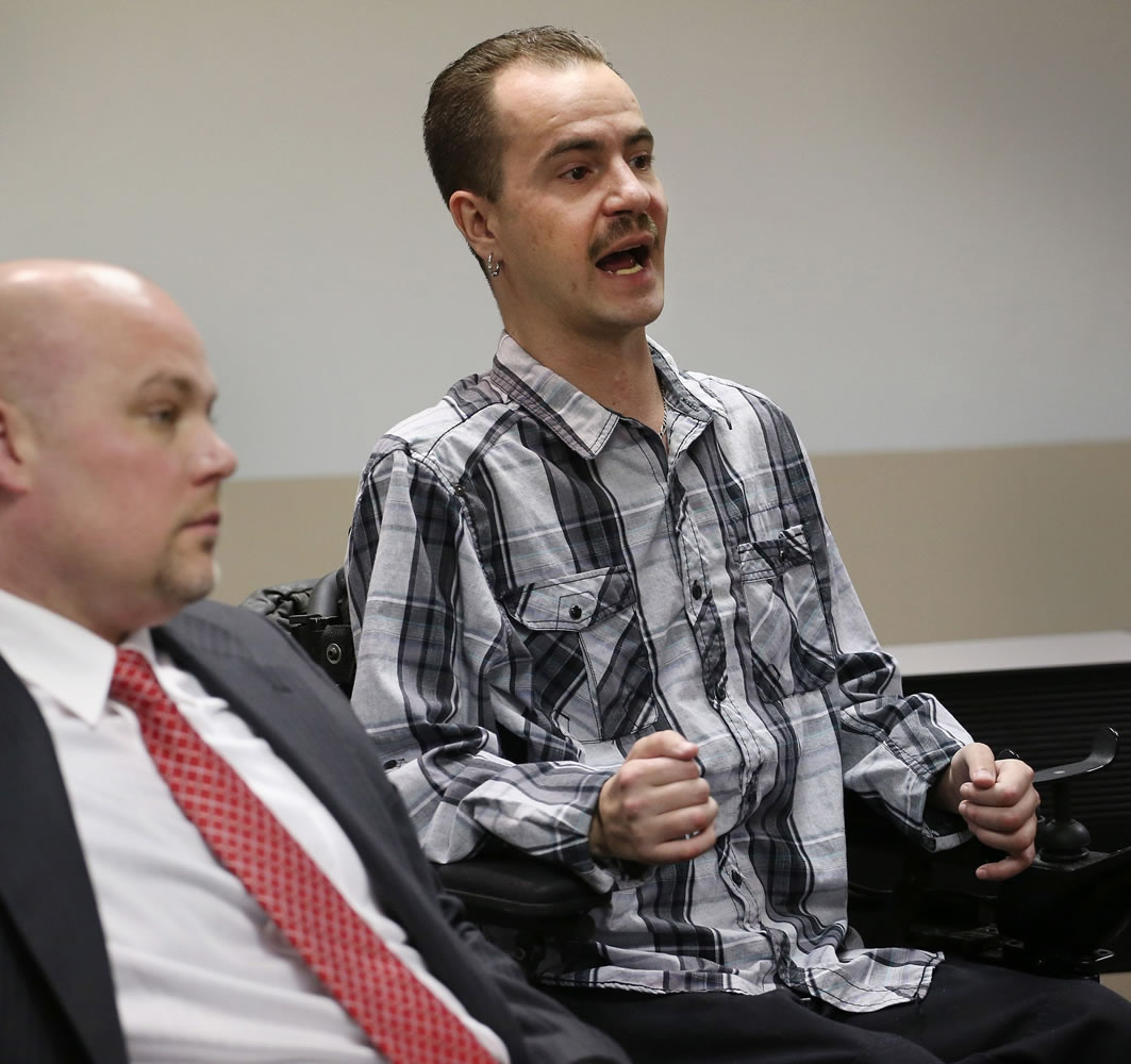 Attorney Michael Evans, left, listens in his office in Denver in 2013, as his client Brandon Coats talks about the Colorado Court of Appeals ruling that upheld Coats being fired from his job after testing positive for the use of medical marijuana.