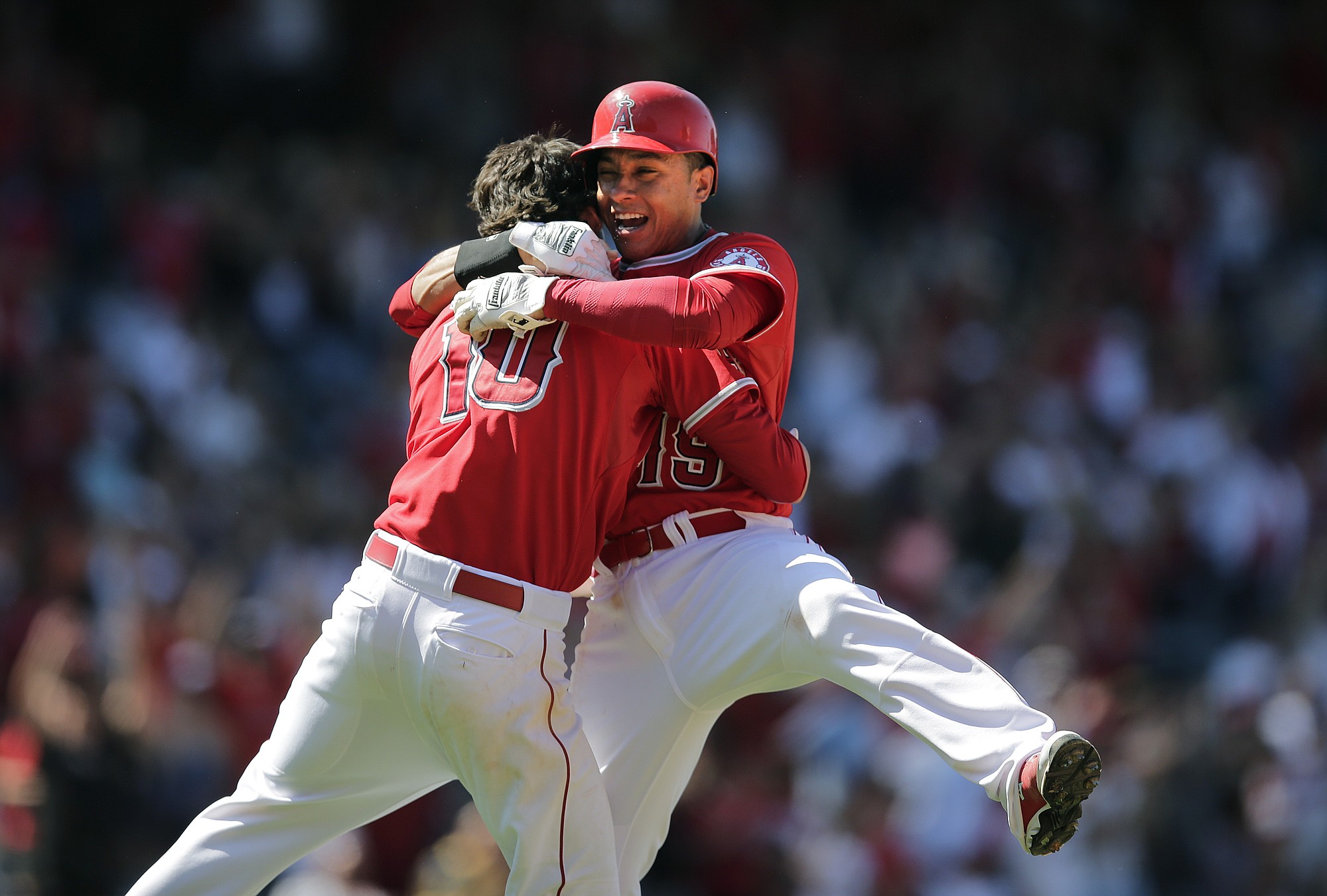 Los Angeles Angels' Grant Green, left, celebrates his ninth-inning walk-off single with Efren Navarro as the Angels beat the Seattle Mariners on Sunday, 6-5. (AP Photo/Jae C.