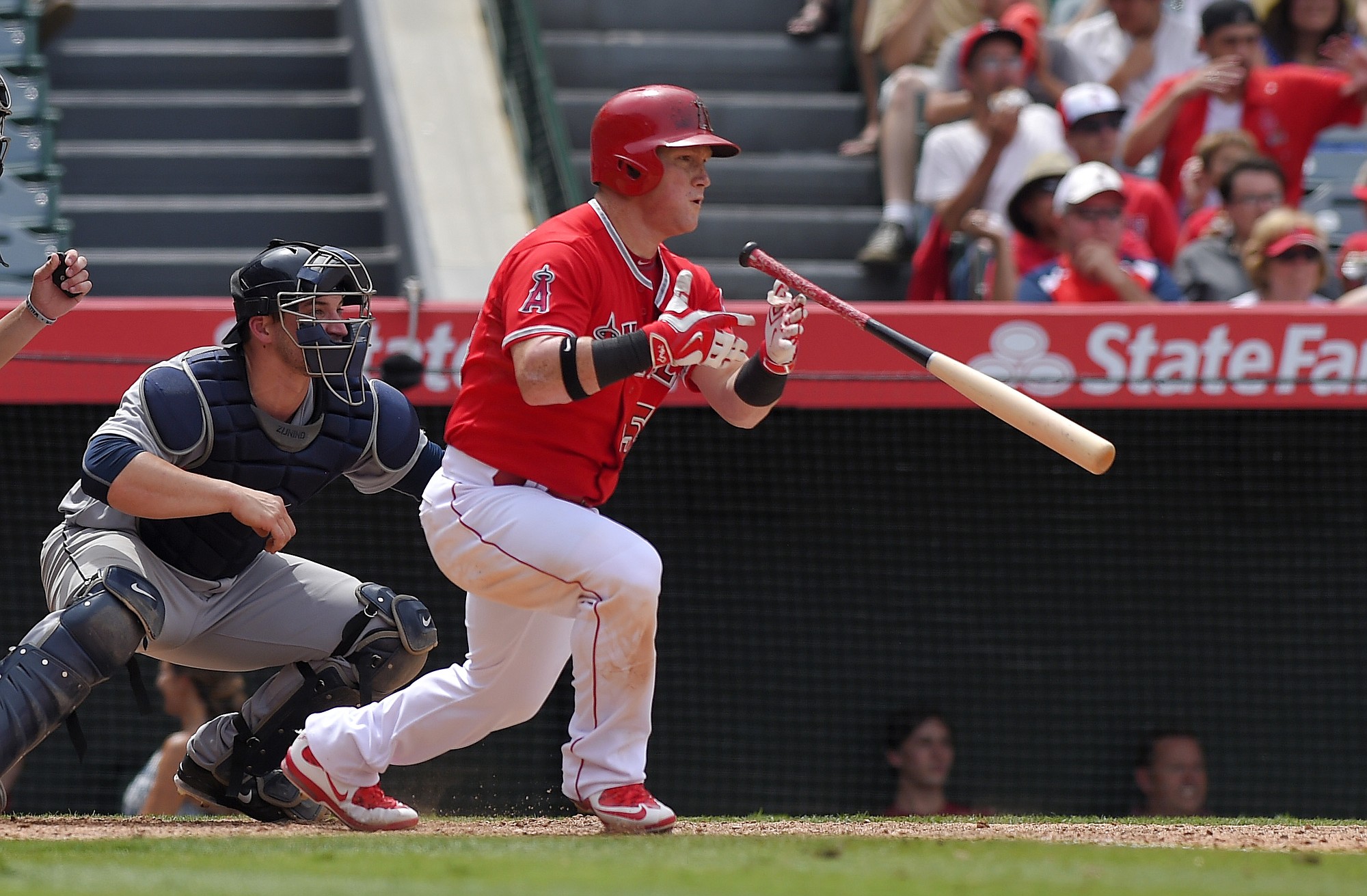 Los Angeles Angels' Kole Calhoun, right, hits an RBI-single as Seattle Mariners catcher Mike Zunino looks on during the eighth inning Sunday, June 28, 2015, in Anaheim, Calif. (AP Photo/Mark J.