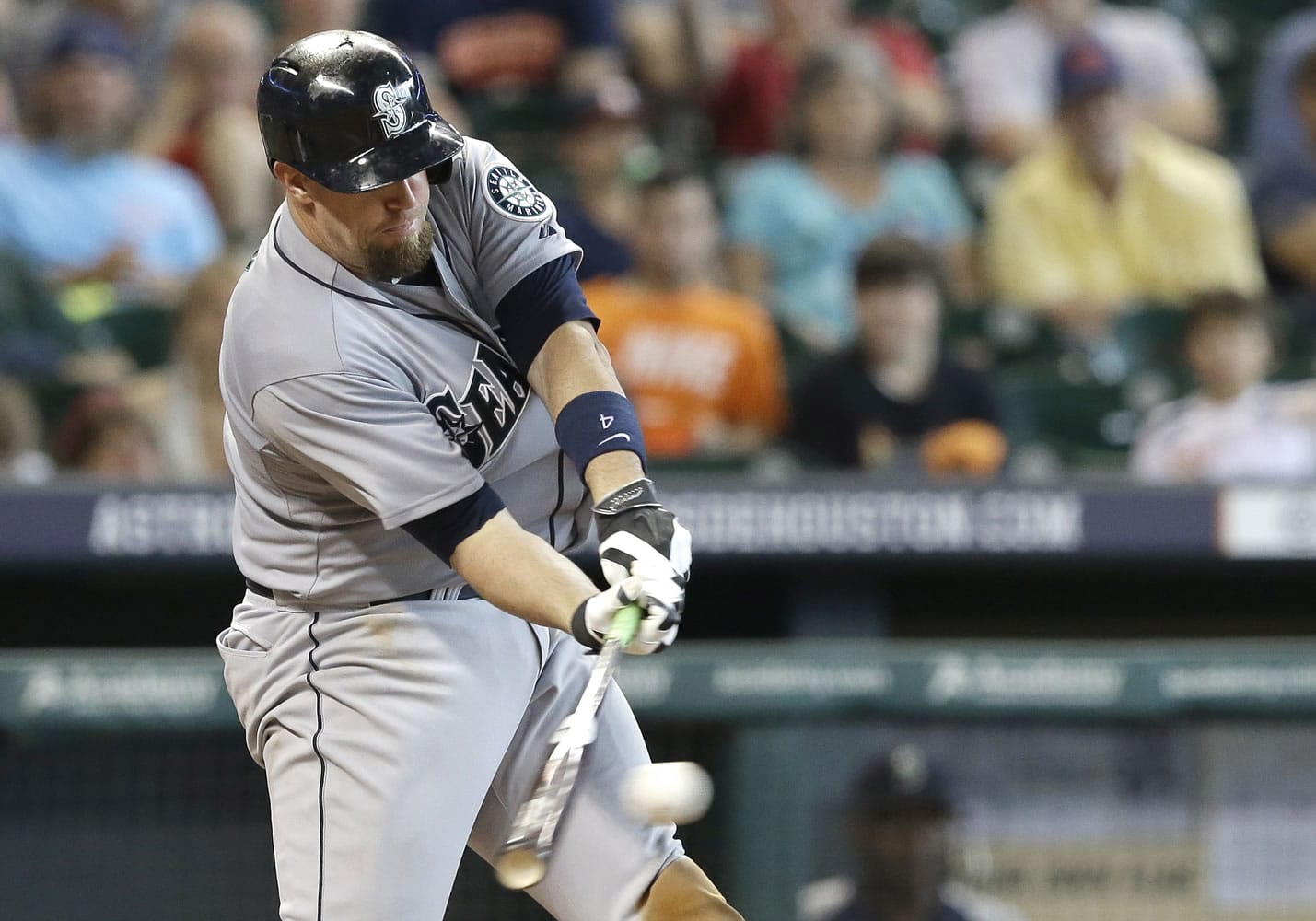 Seattle Mariners' John Buck hits an RBI single against the Houston Astros in the sixth inning Wednesday in Houston.