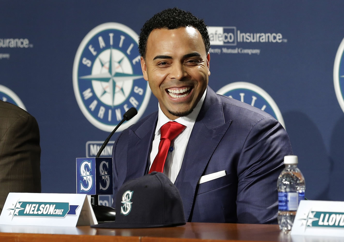 Seattle Mariners' Nelson Cruz smiles as he talks to reporters after being introduced at a baseball news conference, Thursday, Dec.