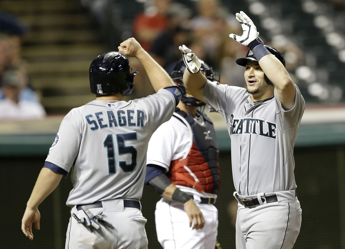 Seattle Mariners' Mike Zunino, right, is congratulated by Kyle Seager after Zunino hit a two-run home run off Cleveland Indians relief pitcher Bryan Shaw in the eighth inning Thursday, July 31, 2014, in Cleveland. Seager scored on the play.