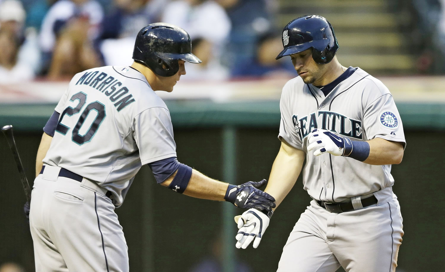 Seattle Mariners' Mike Zunino, right, is congratulated by Logan Morrison after Zunino hit a solo home run off Cleveland Indians starting pitcher Trevor Bauer in the fifth inning Tuesday in Cleveland.