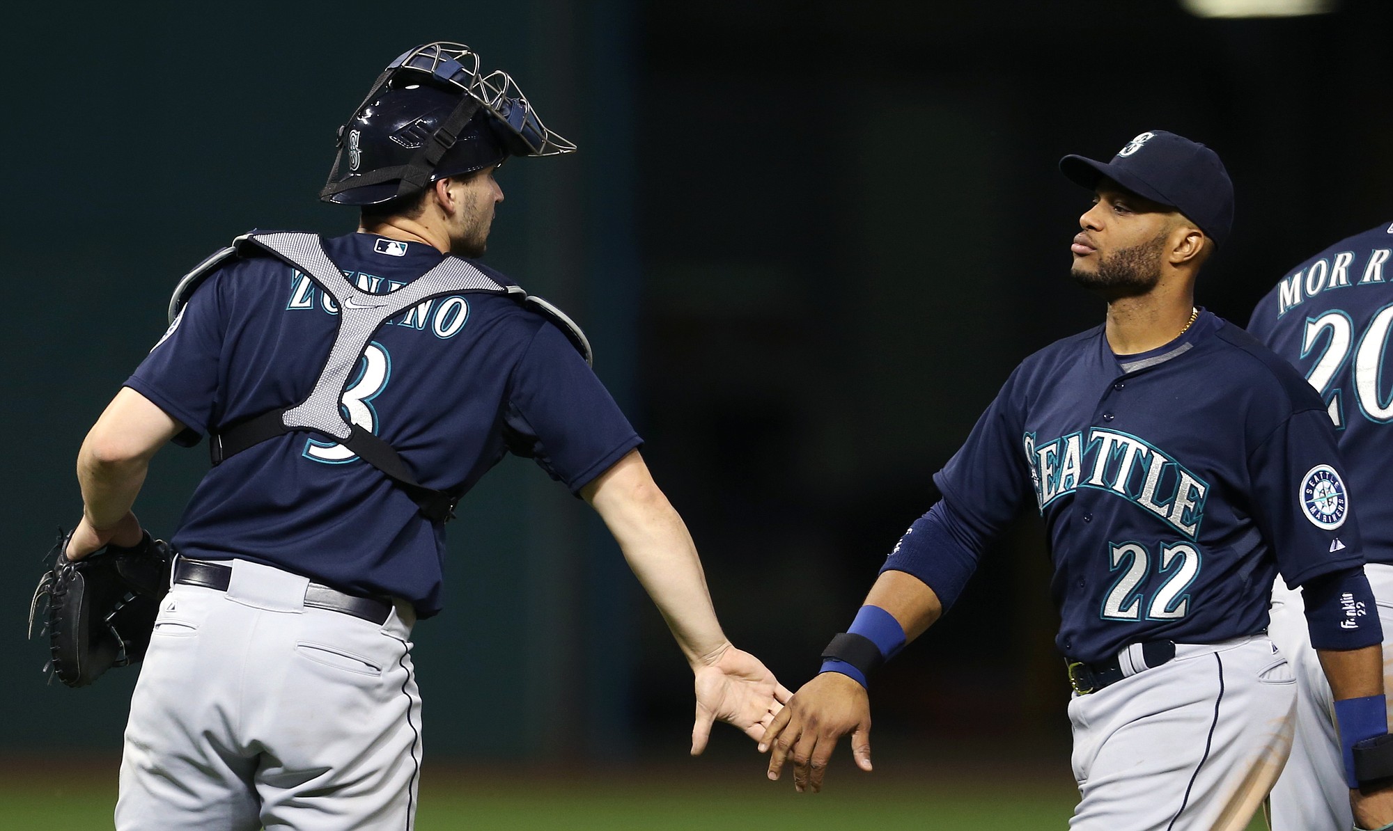Seattle Mariners catcher Mike Zunino, left, and Robinson Cano celebrate after beating the Cleveland Indians 3-2 Tuesday in Cleveland.
