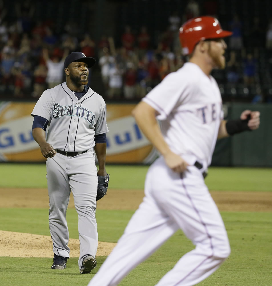 lm otero/Associated Press
Seattle pitcher Fernando Rodney, left, trudges off the field as Ryan Strausborger walks home from third base to score the winning run on a bases-loaded walk.