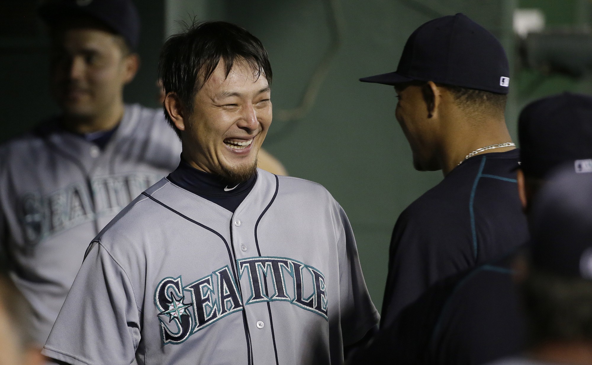 LM Otero/Associated Press
Mariners pitcher Hisashi Iwakuma, of Japan, laughs with teammates after the seventh inning of Seattle's 3-2 win.