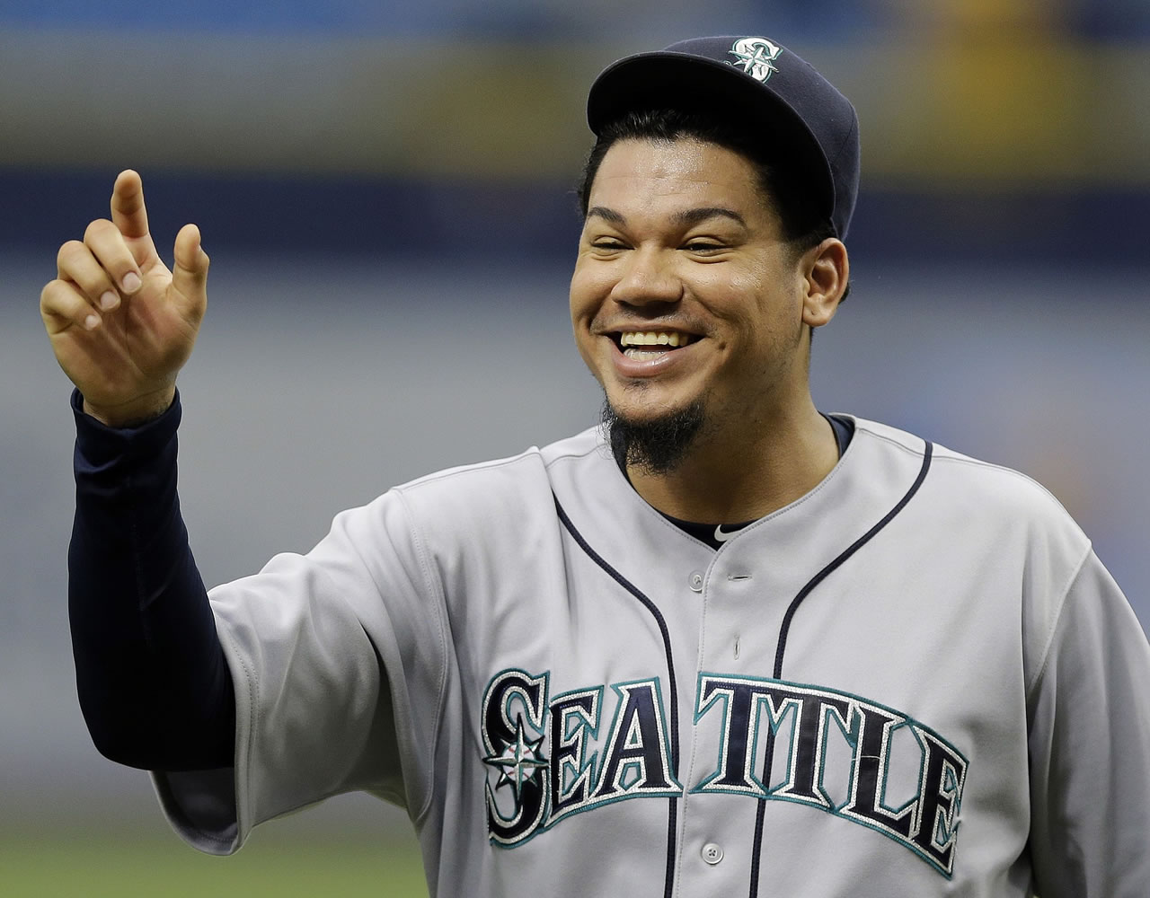 Seattle Mariners starting pitcher Felix Hernandez reacts as he in congratulated by teammates after his complete game shutout of the Tampa Bay Rays during a baseball game Wednesday, May 27, 2015, in St. Petersburg, Fla.  The Mariners won the game 3-0.