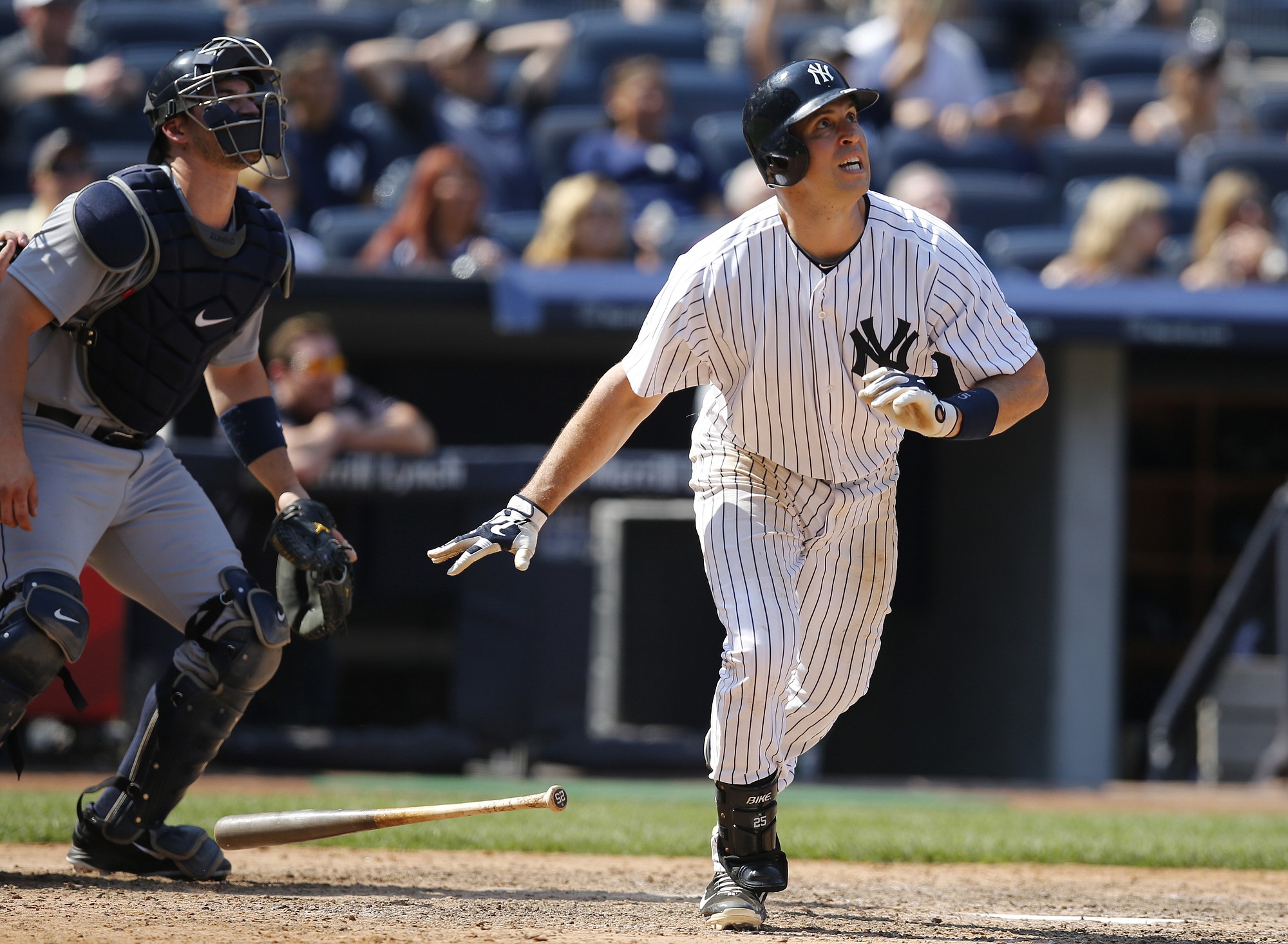 Seattle Mariners catcher Mike Zunino, left, and New York Yankees Mark Teixeira watch Texeira's eighth-inning, tie-breaking, go-ahead, solo home run at Yankee Stadium in New York, Sunday, July 19, 2015.