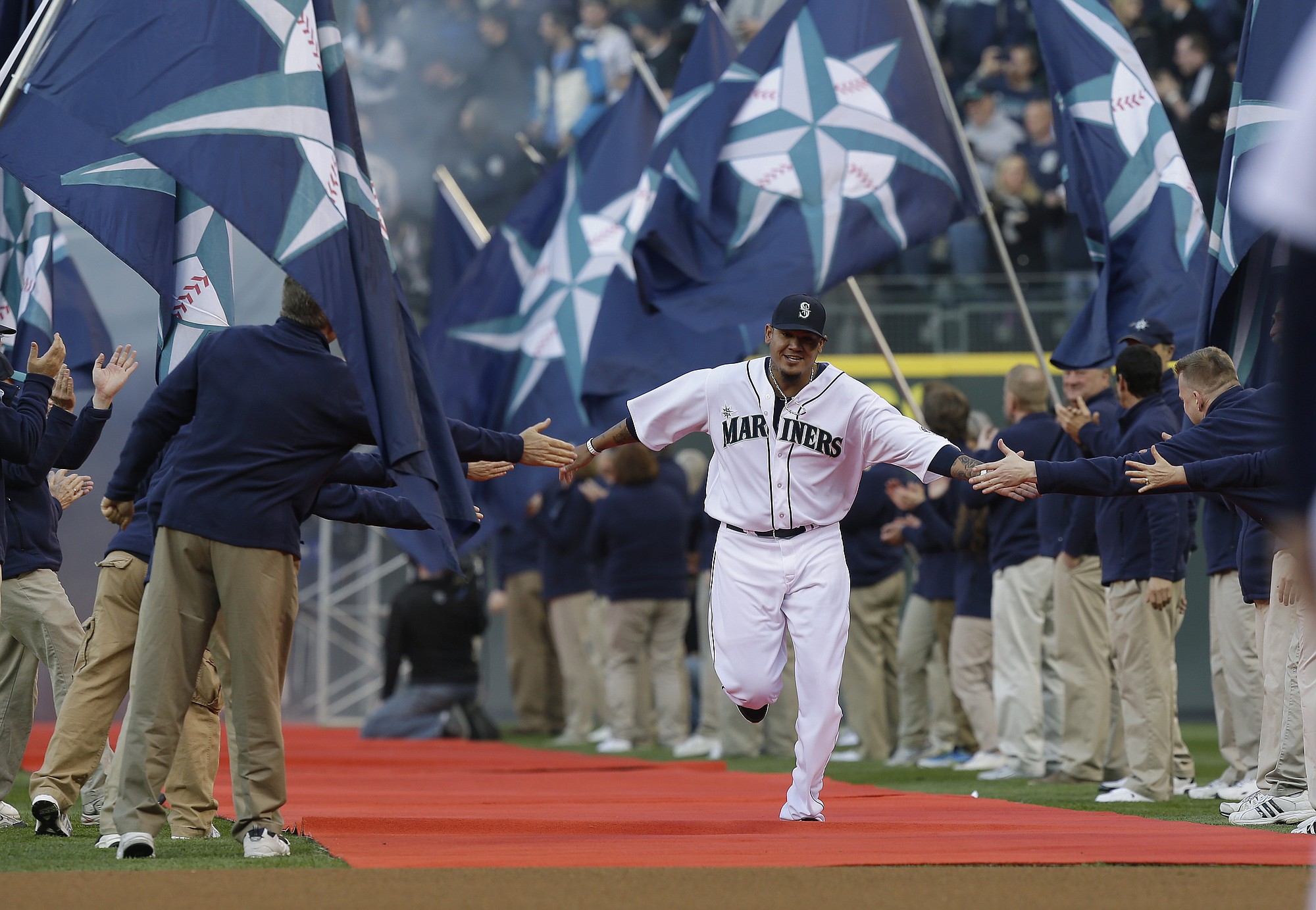 Seattle Mariners ace Felix Hernandez runs down the red carpet during team introductions prior to the Mariners' home opener against the Houston Astros on Monday.