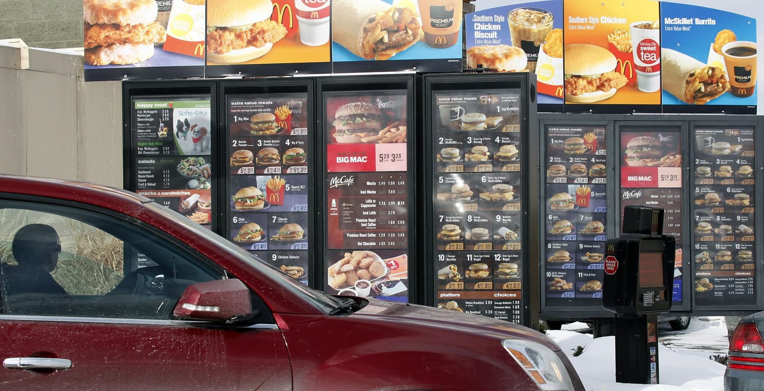 Associated Press files
A customer looks at the menu while in line at a McDonald's drive-thru in Williamsville, N.Y.