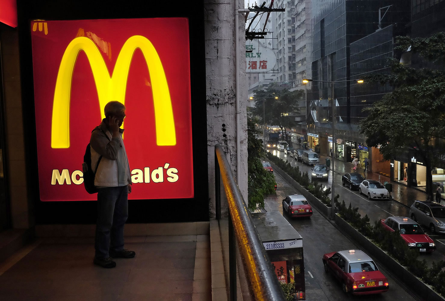 Associated Press files
A man talks on a mobile phone next to a downtown McDonald's in Hong Kong.