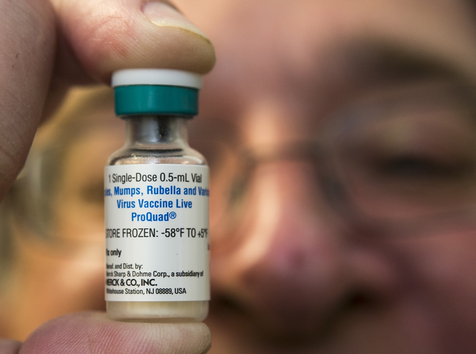 A pediatrician holds a dose of the measles-mumps-rubella (MMR) vaccine (AP Photo/Damian Dovarganes)