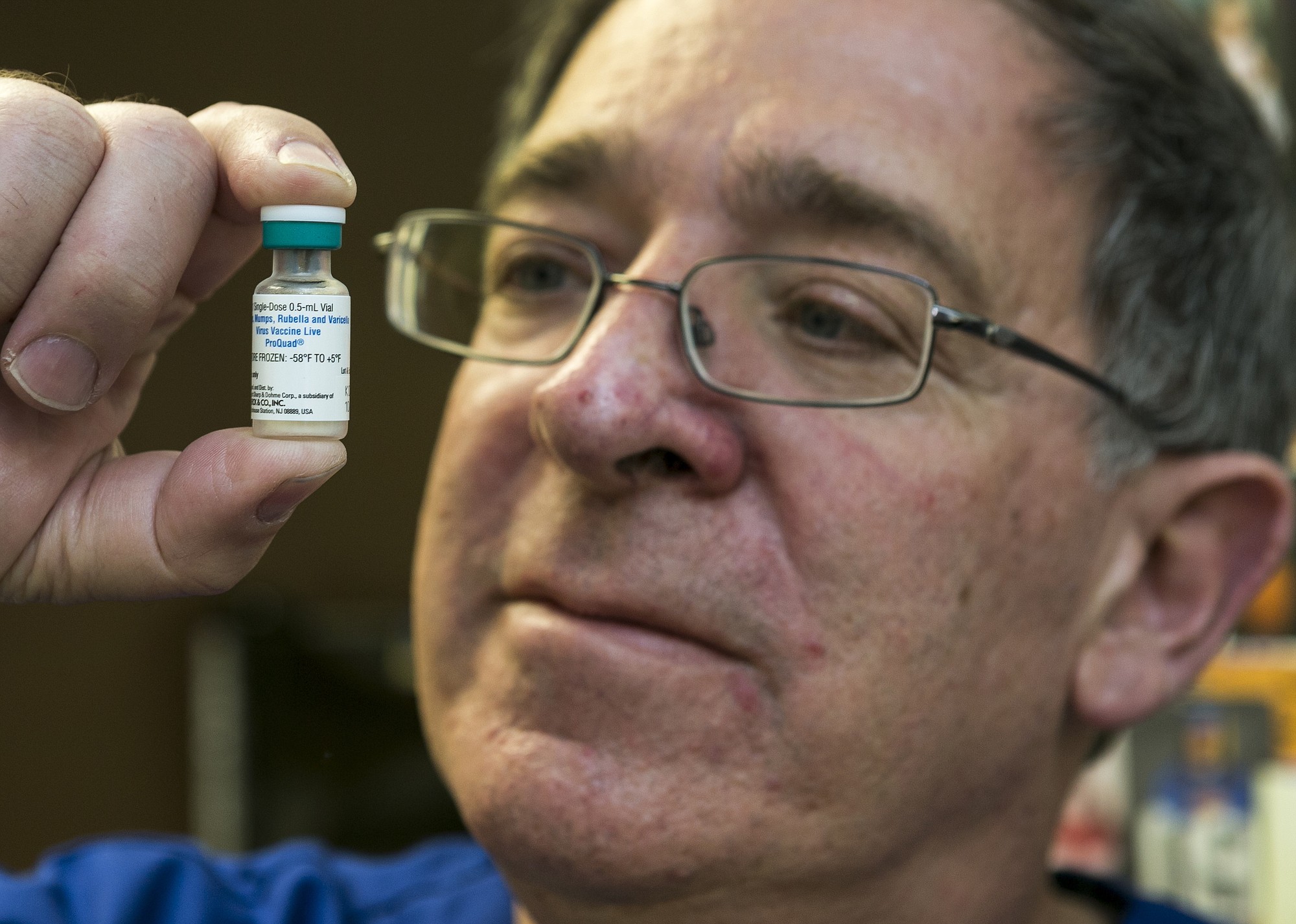 Pediatrician Charles Goodman holds a dose of the measles-mumps-rubella vaccine, or MMR, vaccine Thursday at his practice in Northridge, Calif. Some doctors won't accept patients who don't believe in vaccinations, with some saying they don't want to be responsible for someone's death from an illness that was preventable.