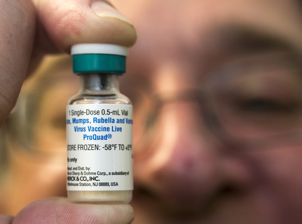 A pediatrician holds a dose of the measles-mumps-rubella (MMR) vaccine Jan. 29 at his practice in Northridge, Calif.
