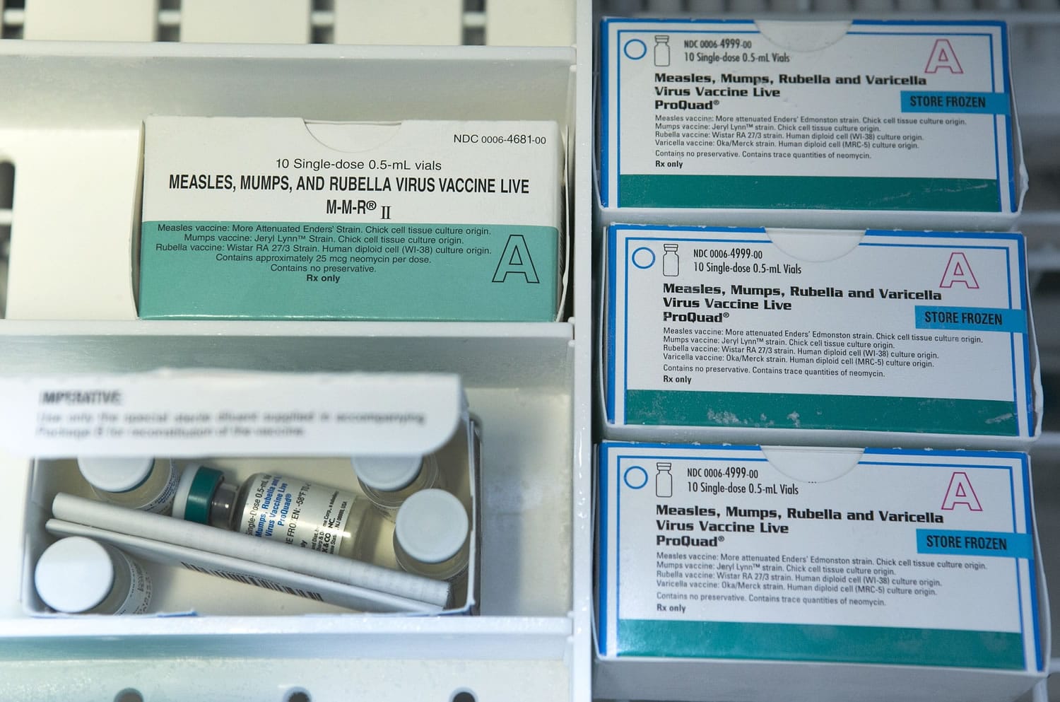 Boxes of the measles, mumps and rubella virus vaccine and measles, mumps, rubella and varicella vaccine are shown inside a freezer at a doctor's office in Northridge, Calif.