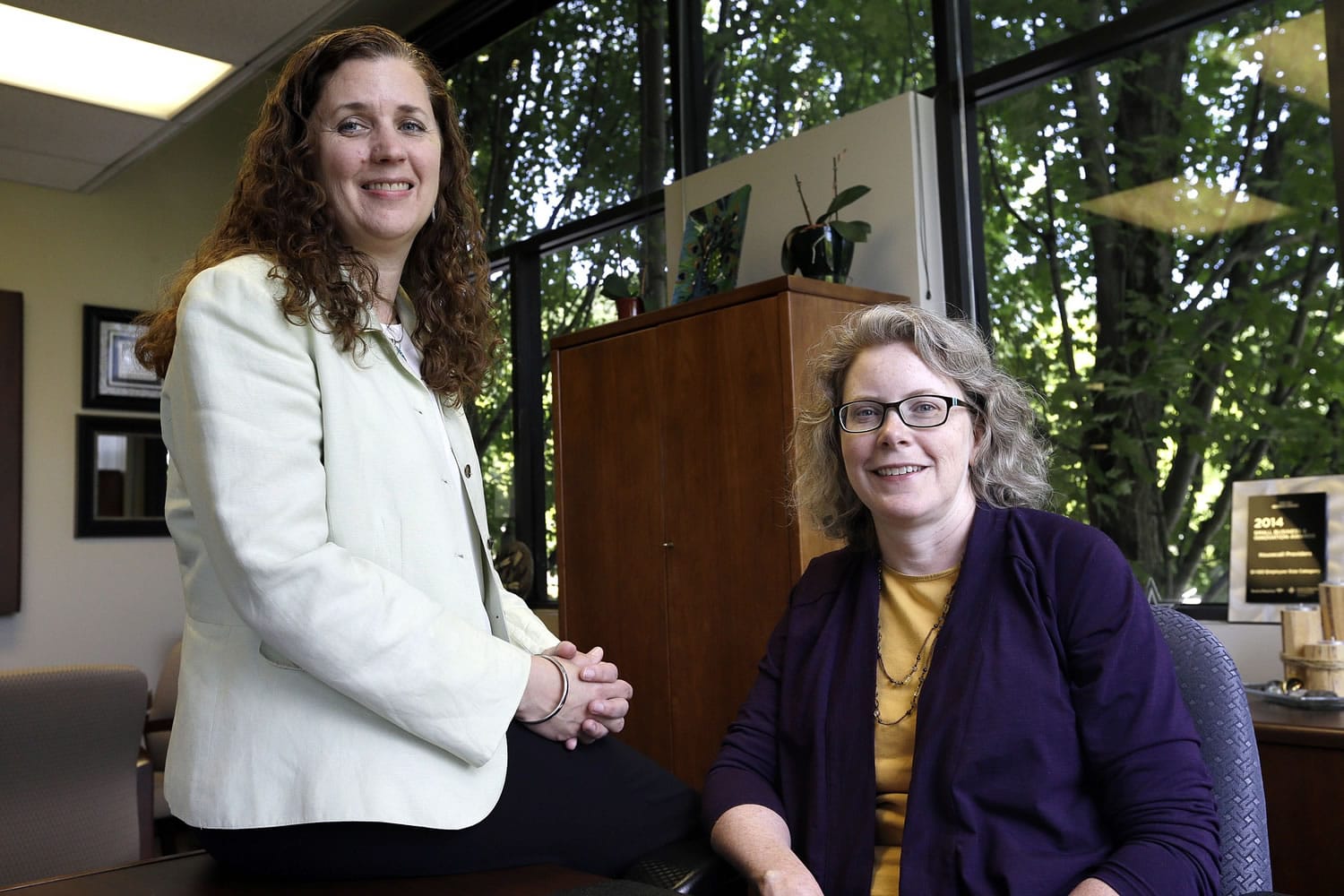 Dr. Pamela Miner, right, and nurse Mary Sayre pose for a photo at the Housecall Providers office in Portland.