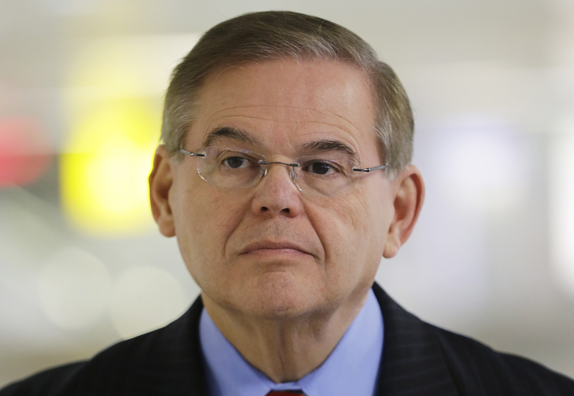 Sen. Robert Menendez, D-N.J., listens March 1, 2013, during a news conference, at Newark Liberty International Airport in Newark, N.J. Attorney General Eric Holder is declining to say if he has approved the filing of corruption charges against Menendez.