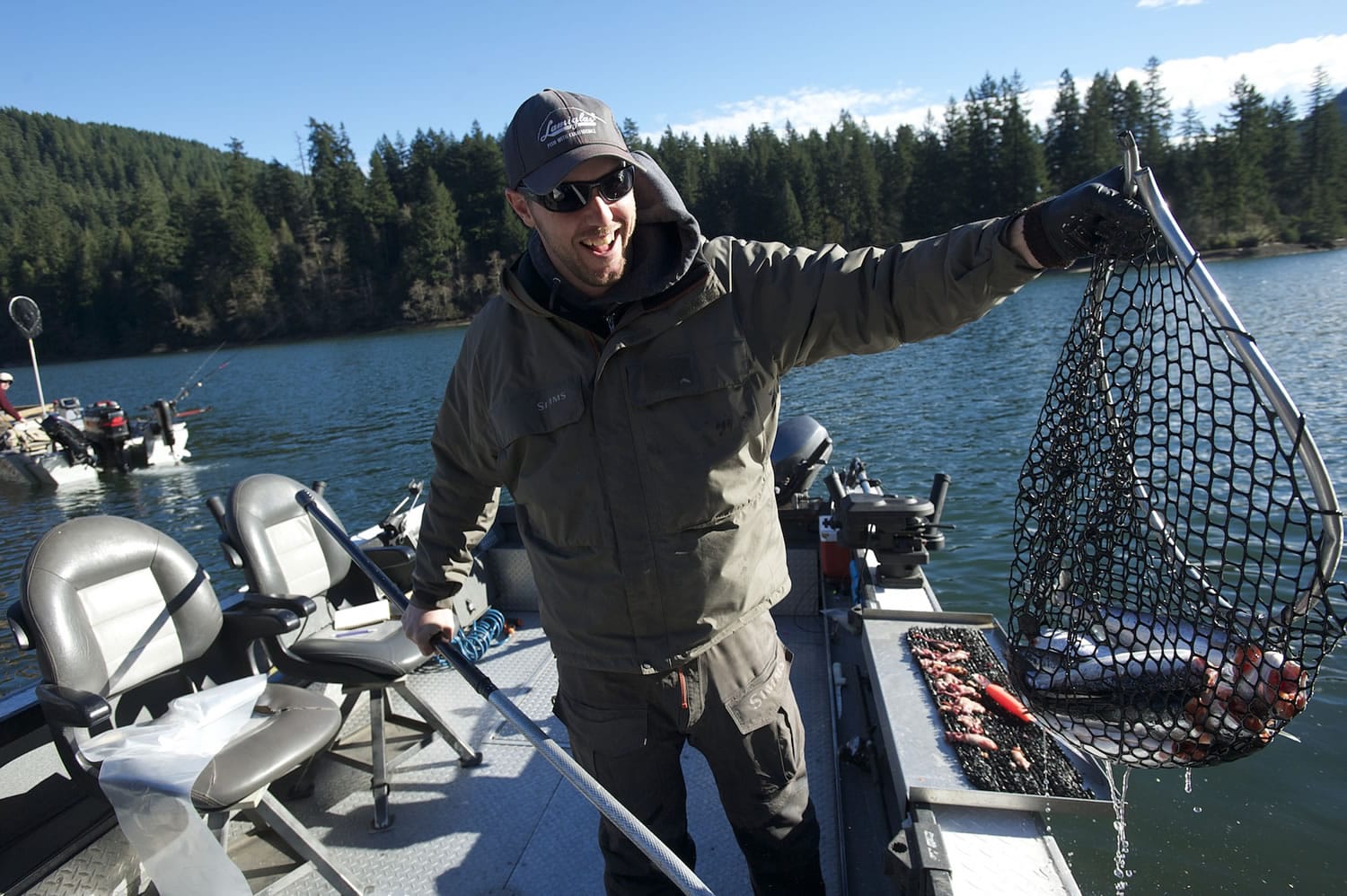Guide Cameron Black of Woodland cleans a catch of kokanee at Merwin Reservoir for clients in January.