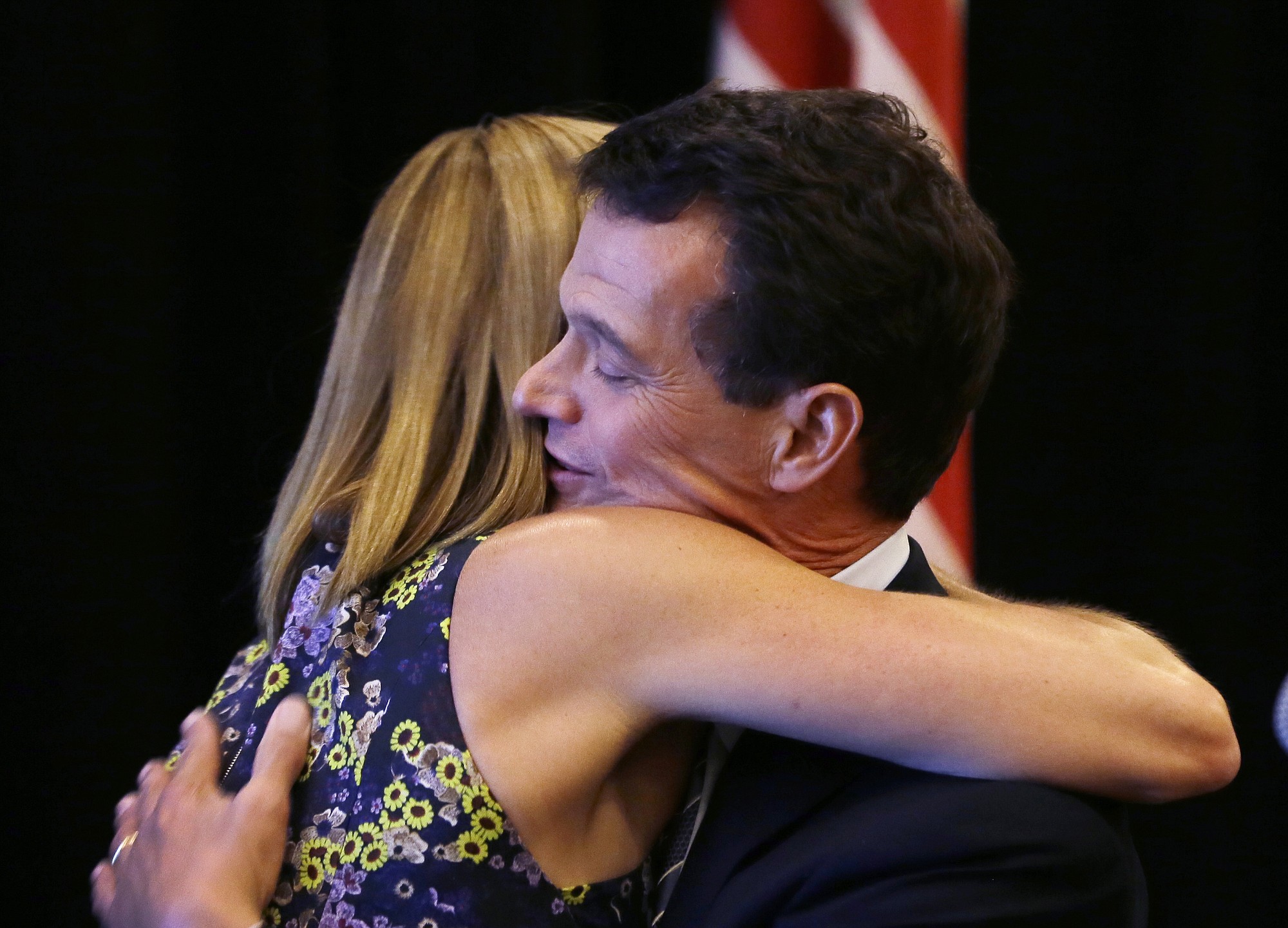 Republican David Trott embraces his wife, Kappy, at his election night party in Troy, Mich., on Tuesday.