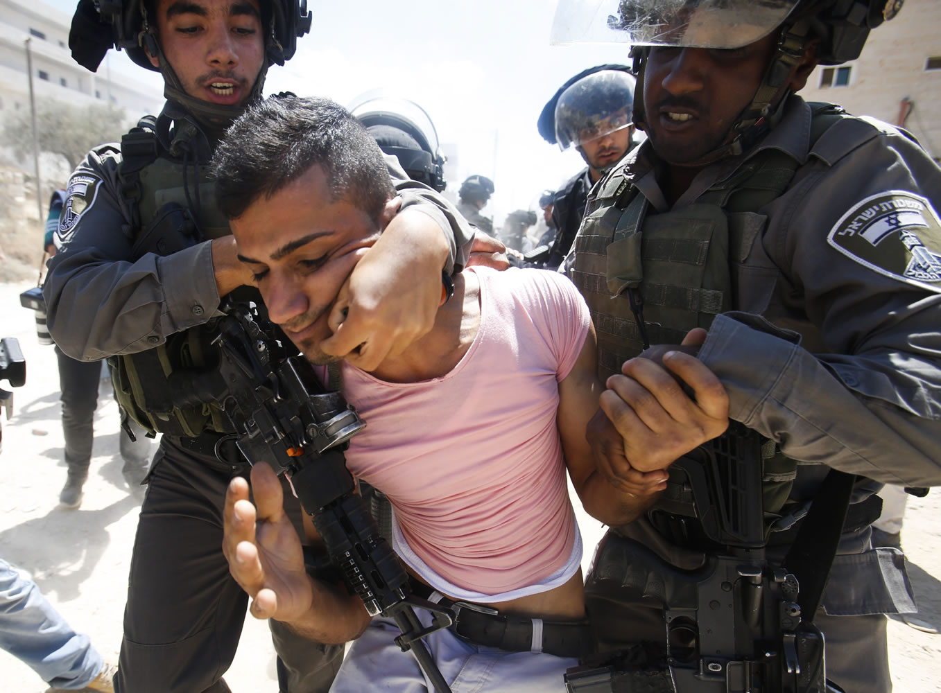 Israeli border police detain a Palestinian during a protest Sunday against the Israeli separation barrier, in Beit Jala, West Bank.