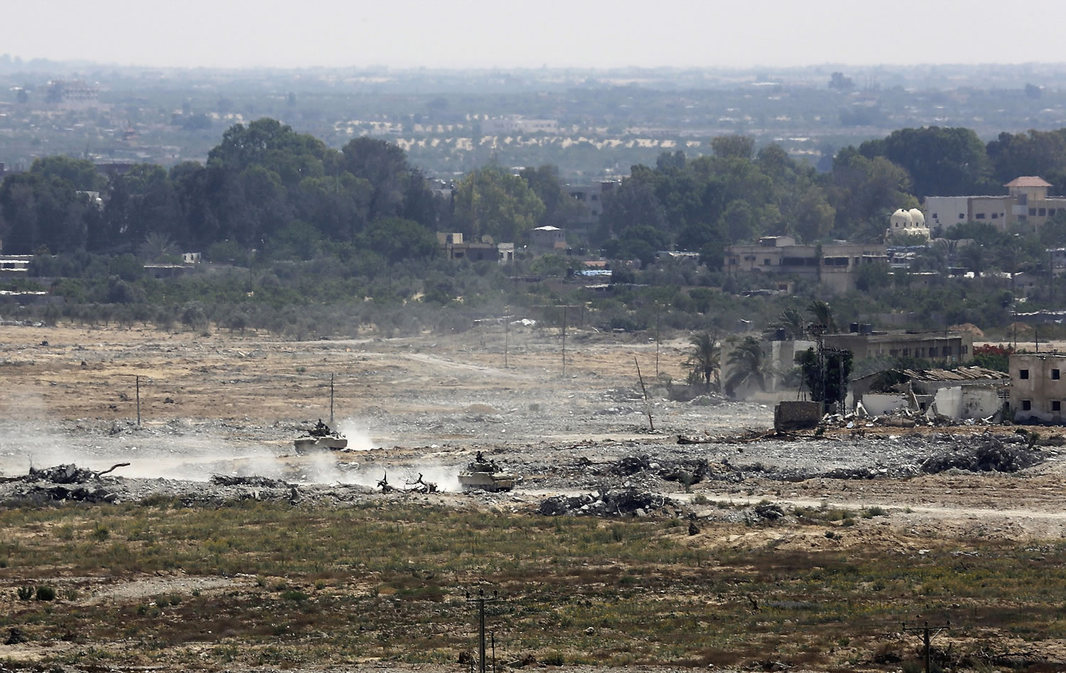 Egyptian armored vehicles patrol Thursday on the Egyptian side of the border, seen from the Gaza Strip.