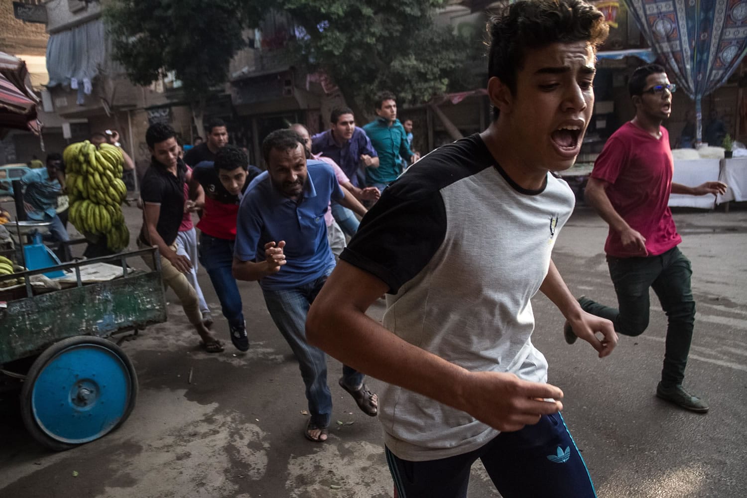 Protesters affiliated with the Muslim Brotherhood run in fear of Egyptian police forces opening fire towards them during a protest on the second anniversary of the ouster of Islamist President Mohammed Morsi in the Matariya district of Cairo.