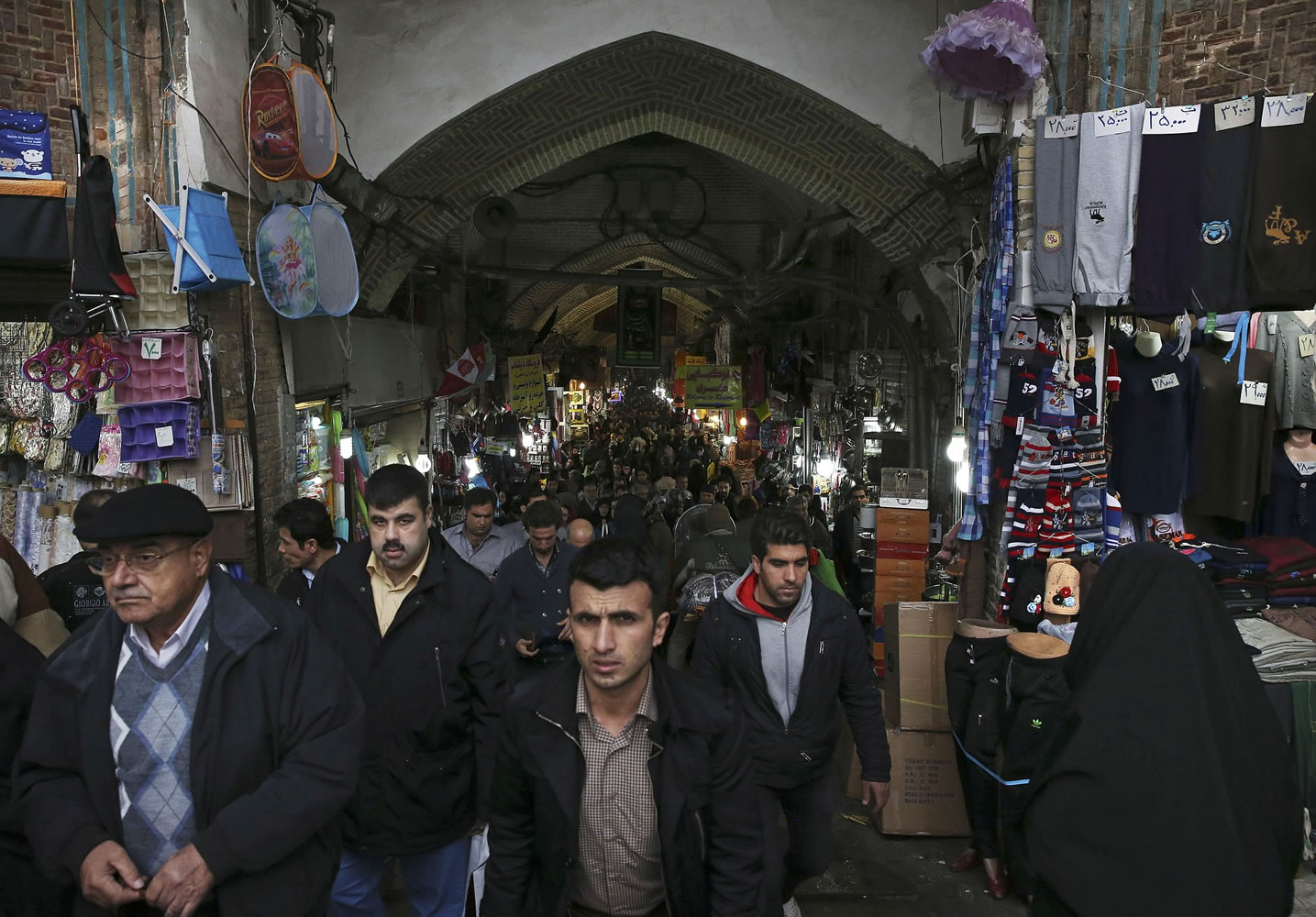 Iranians walk in Tehran's old main bazaar, Iran, Tuesday, Nov. 25, 2014. Iran's Supreme Leader said Tuesday that western powers will not be able to bring the country to its knees in nuclear talks, however he gave his indirect approval for a continuation of those negotiations.
