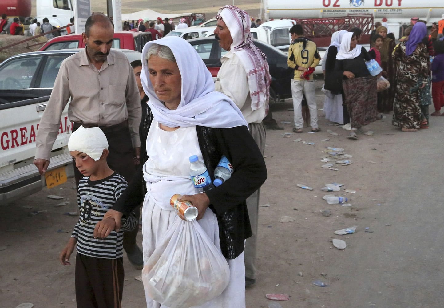 Displaced Iraqis from the Yazidi community arrive Saturday at Feeshkhabour, Iraq, near the Syria-Iraq border.