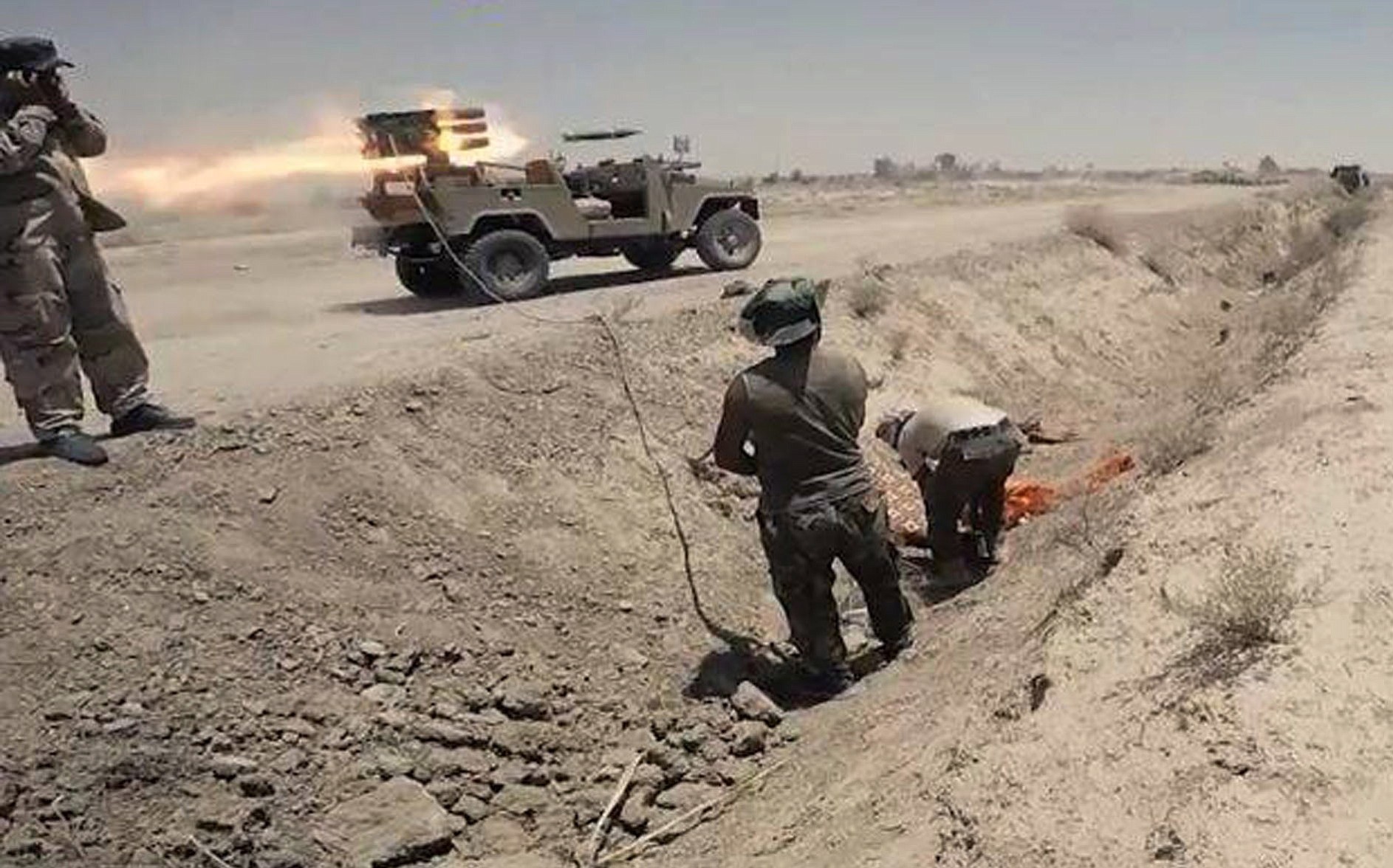 Iraqi security forces and allied Shiite militiamen launch rockets against Islamic State extremist positions in Saqlawiyah near Fallujah, Iraq.