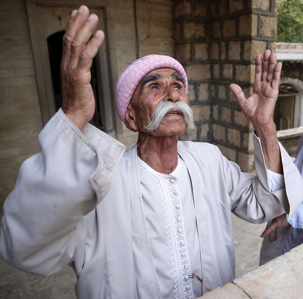 A follower of the ancient Yazidi religion prays at the holy Lalish temple in the Mountains of Shikhan near Dahuk, 260 miles northwest of Baghdad on Monday.