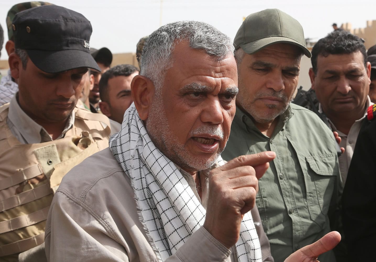 Hadi al-Amiri, center, commander of Iraq's powerful Shiite militias, speaks with The Associated Press on Friday on the battlefield near Tikrit.