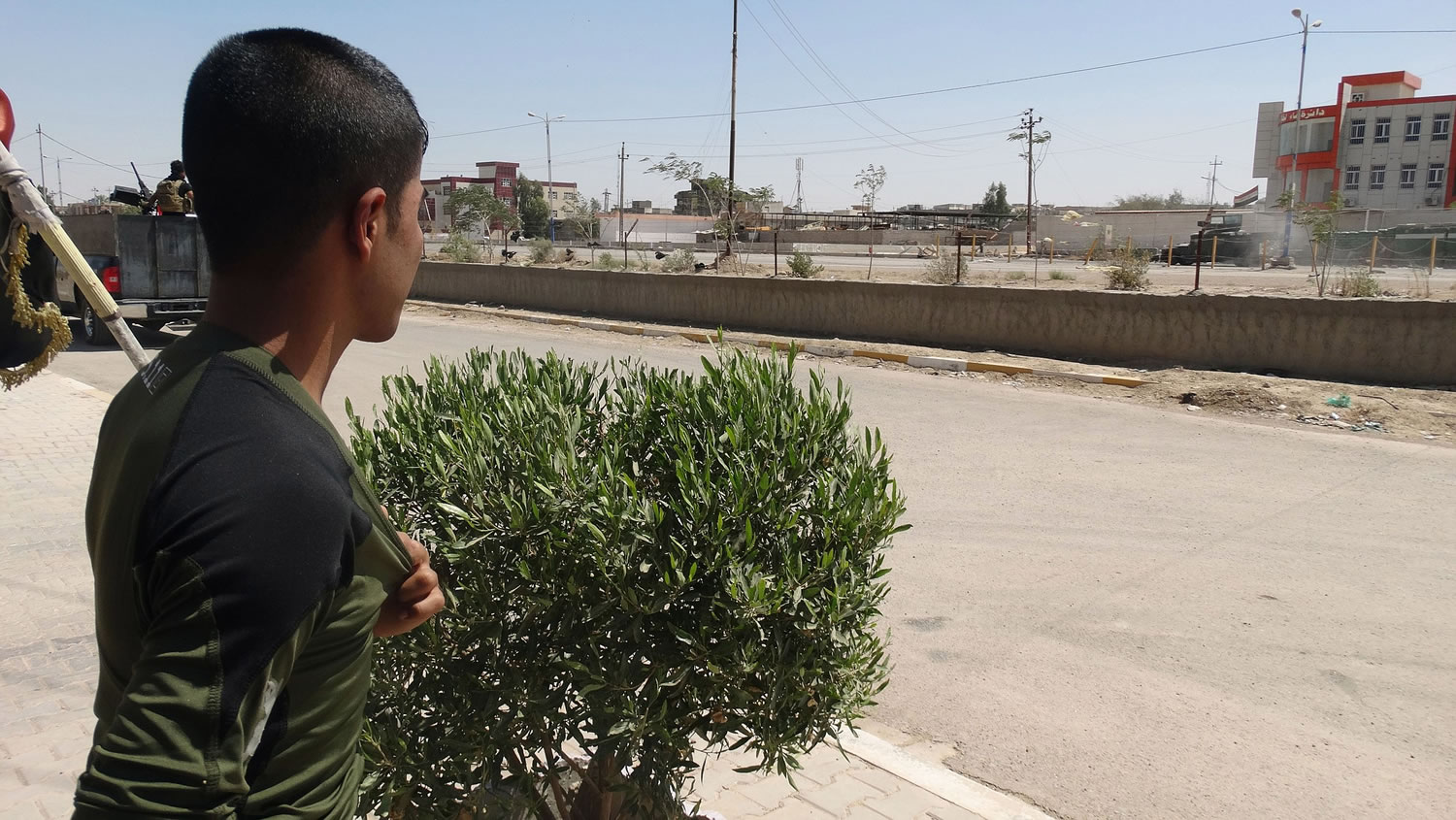 A boy watches Iraq security forces withdraw Sunday from Ramadi, Iraq.
