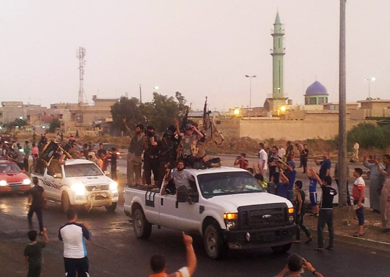 Islamic State fighters parade in the northern Iraqi city of Mosul in June.