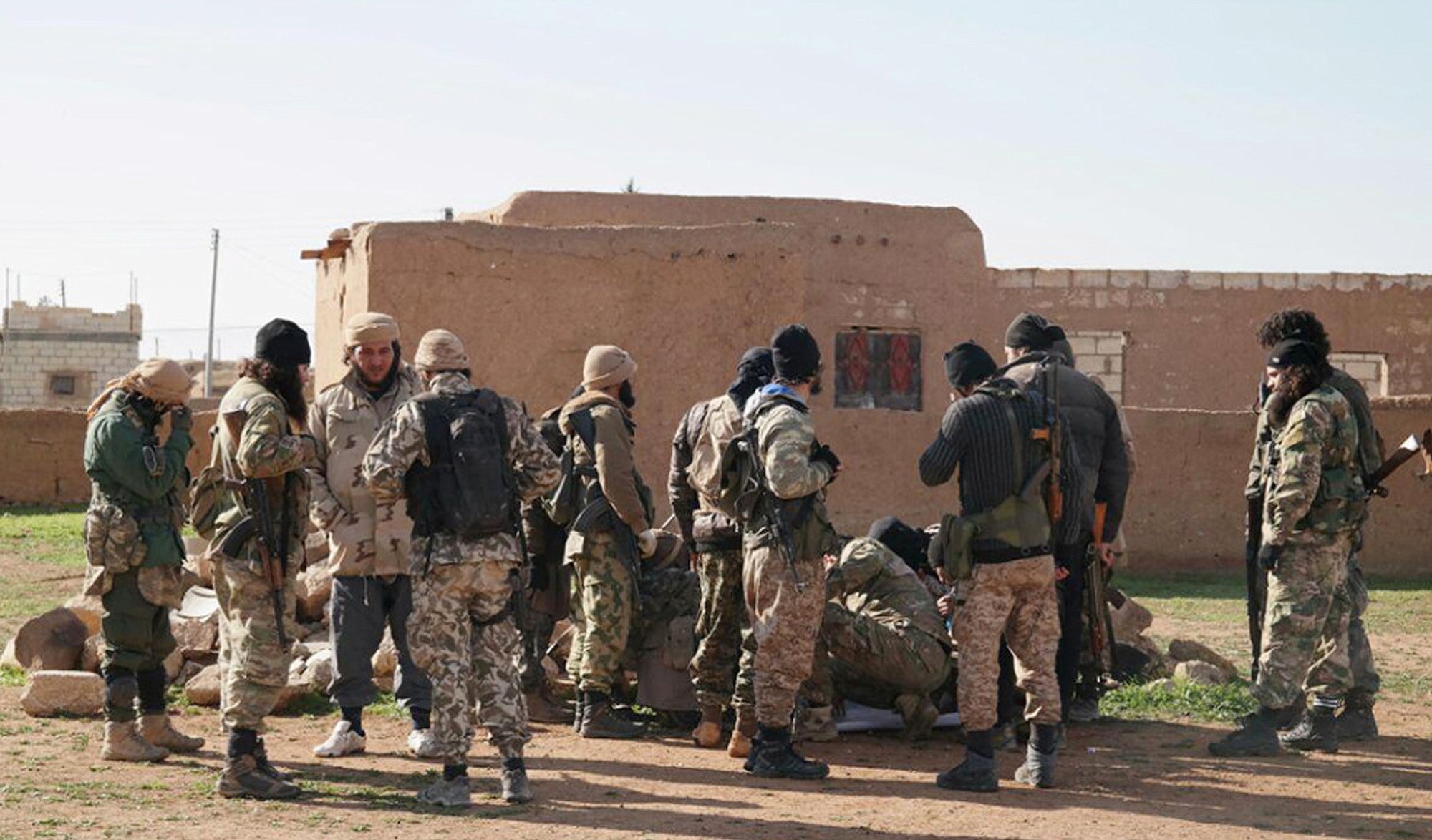 Militants take a break during fighting in Tal Tamr, Hassakeh province, Syria.