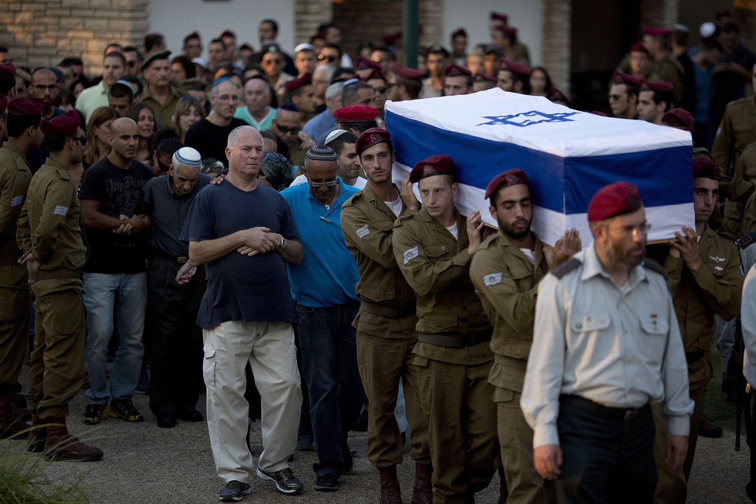 Israeli soldiers carry the coffin Sgt. Bnaya Rubel during his funeral Sunday at the military cemetery in Holon, Israel.