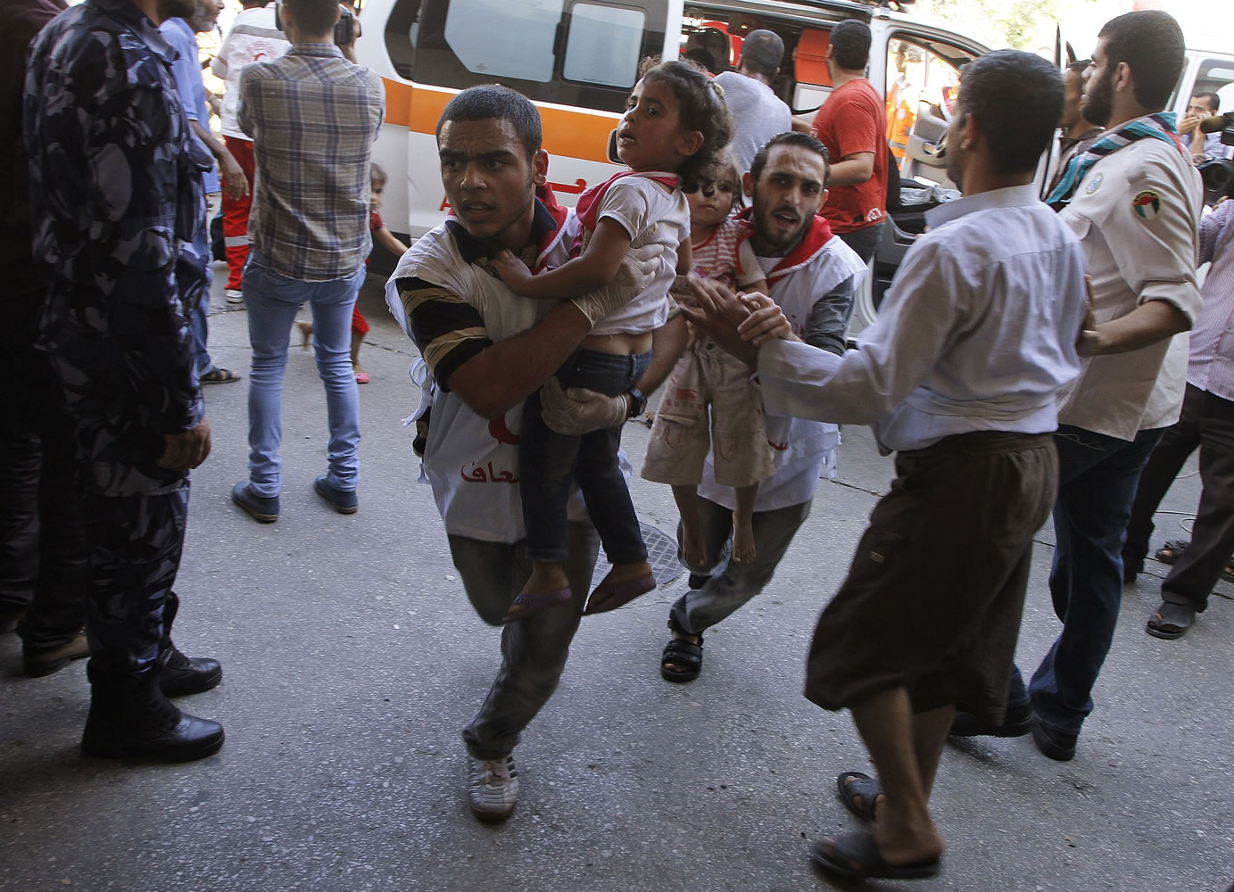Palestinian medics rush children wounded in strike on a compound housing a U.N. school in Beit Hanoun, in the northern Gaza Strip, into the emergency room at Kamal Adwan hospital in Beit Lahiya on Thursday.