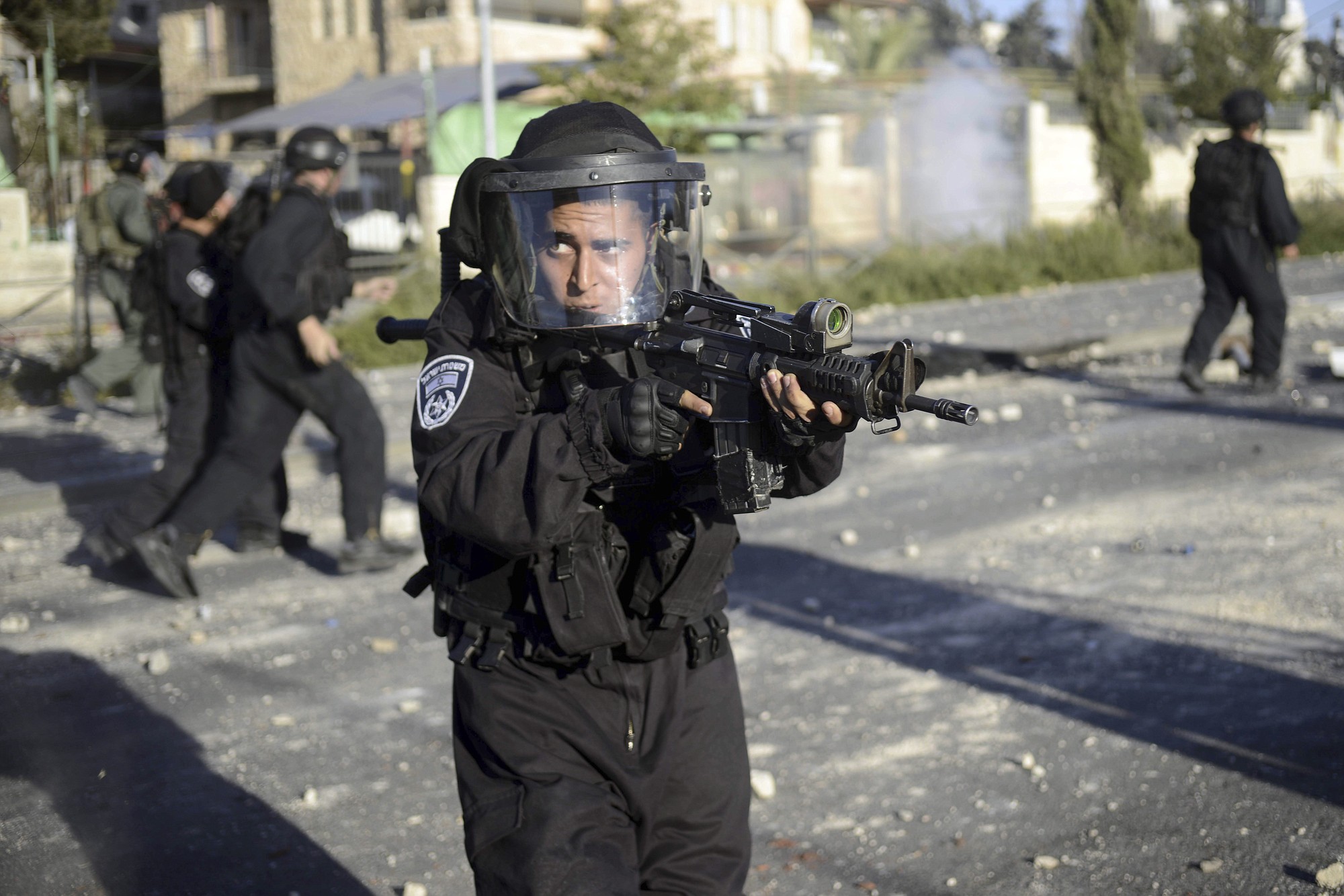 An Israeli border policeman aims his weapon Thursday during clashes with Palestinians in Jerusalem. The violence erupted Wednesday after a 16-year-old Palestinian Mohammed Abu Khdeir was abducted and a charred body, believed to be the boy, was found in a Jerusalem forest.