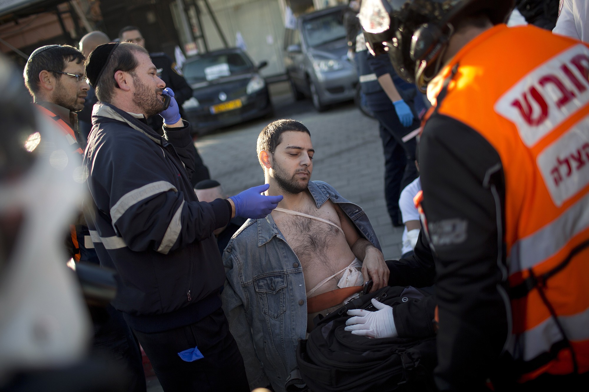 An injured man is treated by paramedics at the scene of a stabbing in Tel Aviv, Israel, on Wednesday.
