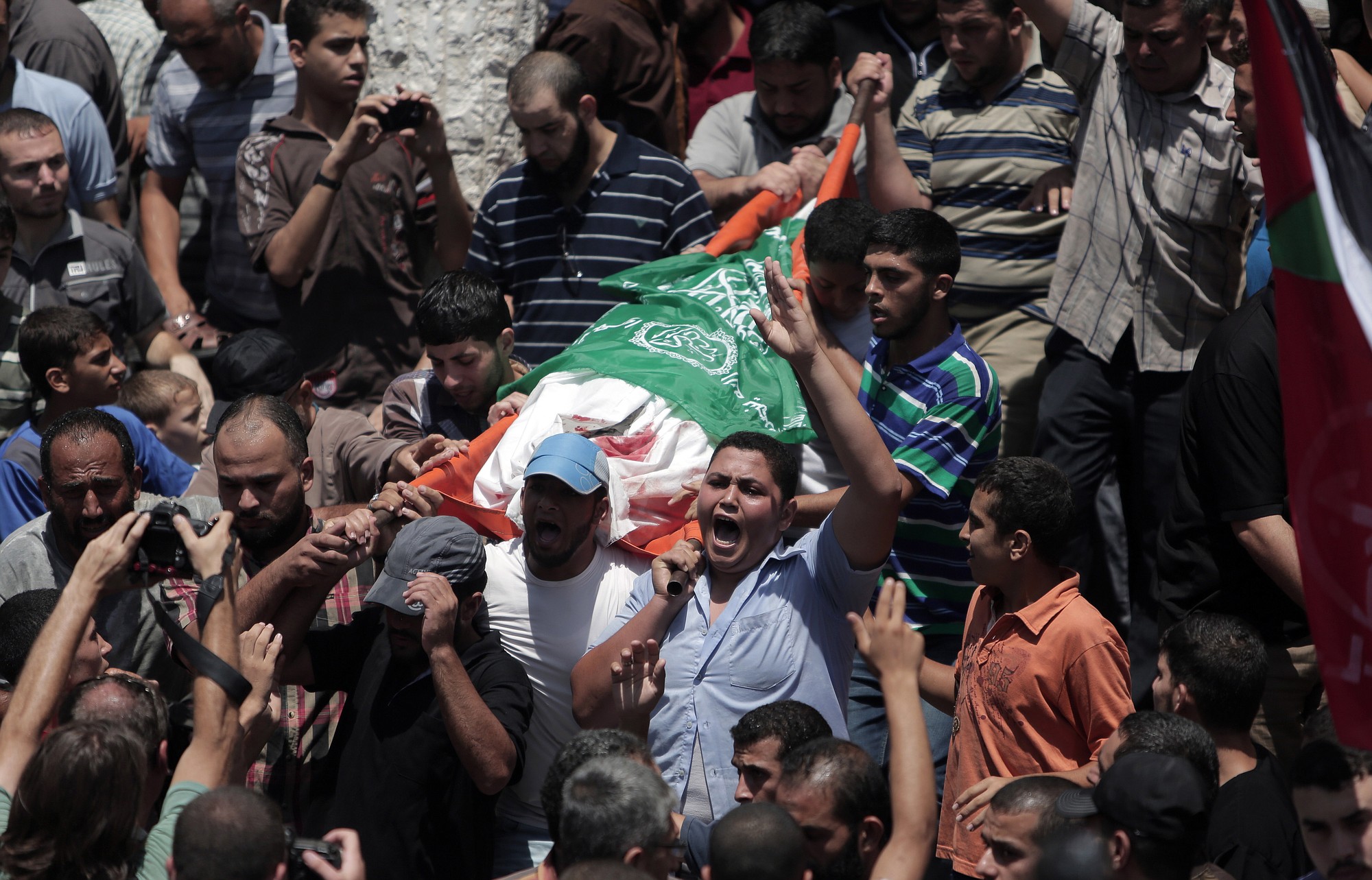 Mourners chant angry slogans during the funeral of Palestinian Widad Mustafa Deif, 27, who was killed along with her 8-month-old son Ali Mohammed Deif in Israeli strikes in Gaza City late Tuesday, during their funeral in Jabaliya refugee camp in the northern Gaza Stri on Wednesday.