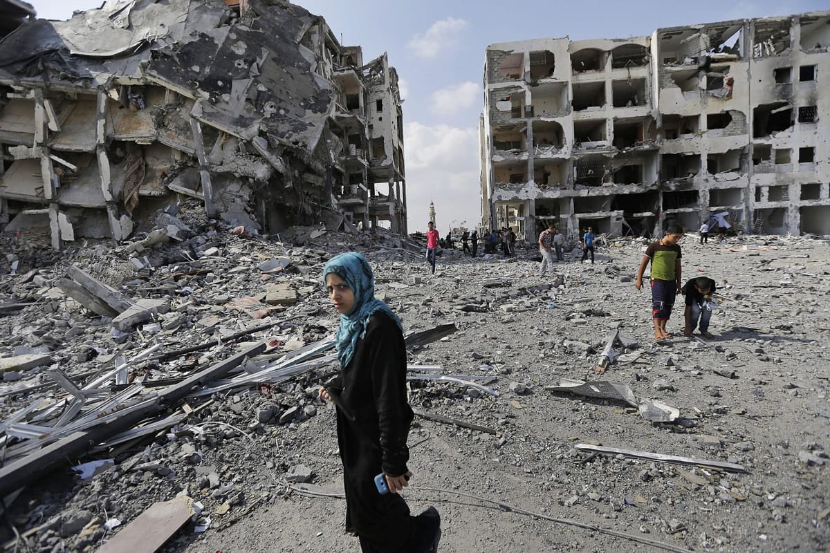 Palestinians inspect the damage to the Nada Towers on Tuesday in a residential neighborhood in Beit Lahiya, northern Gaza Strip.