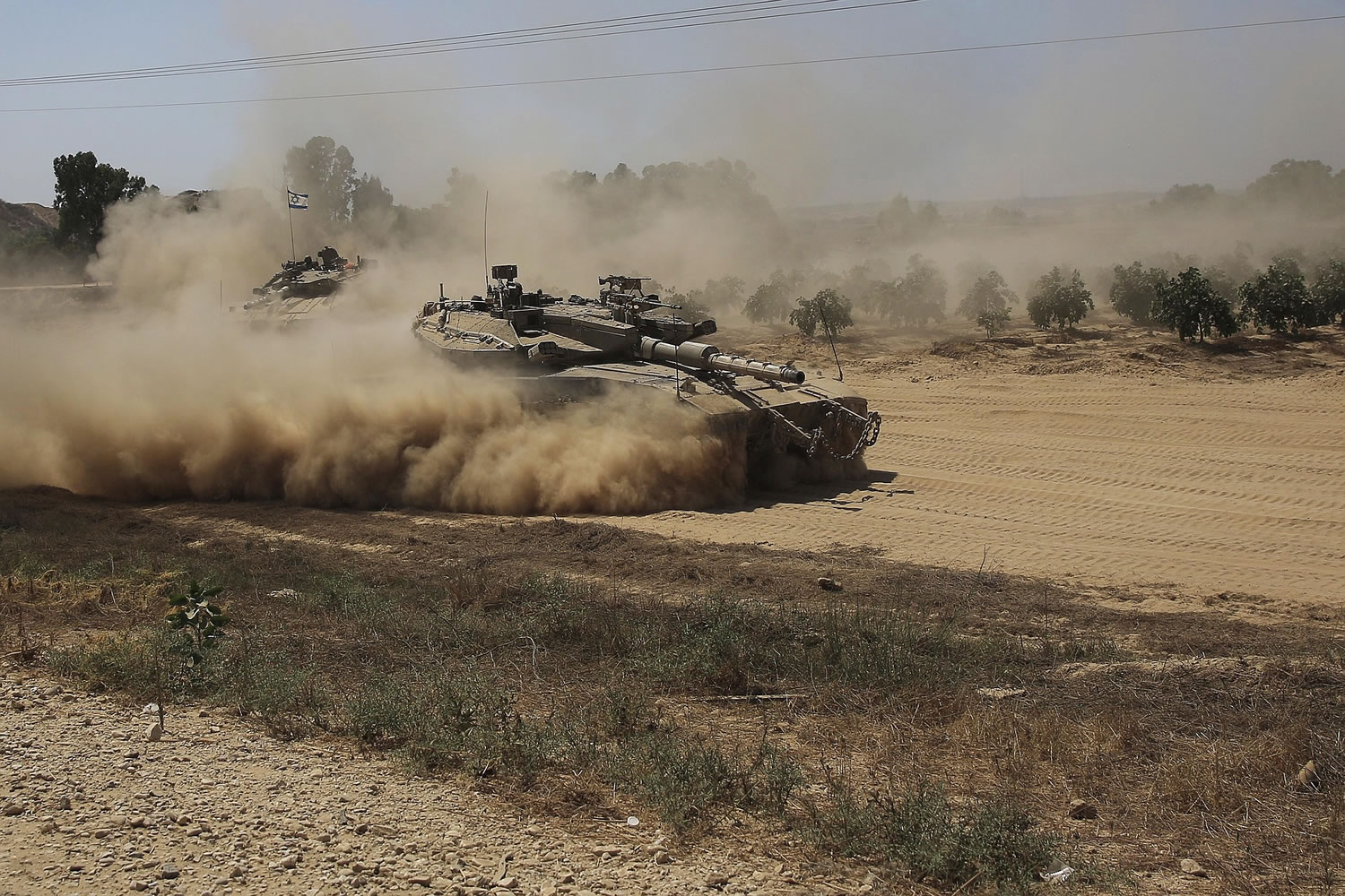 An Israeli tank advances to a staging area near the Israel-Gaza border on Tuesday.