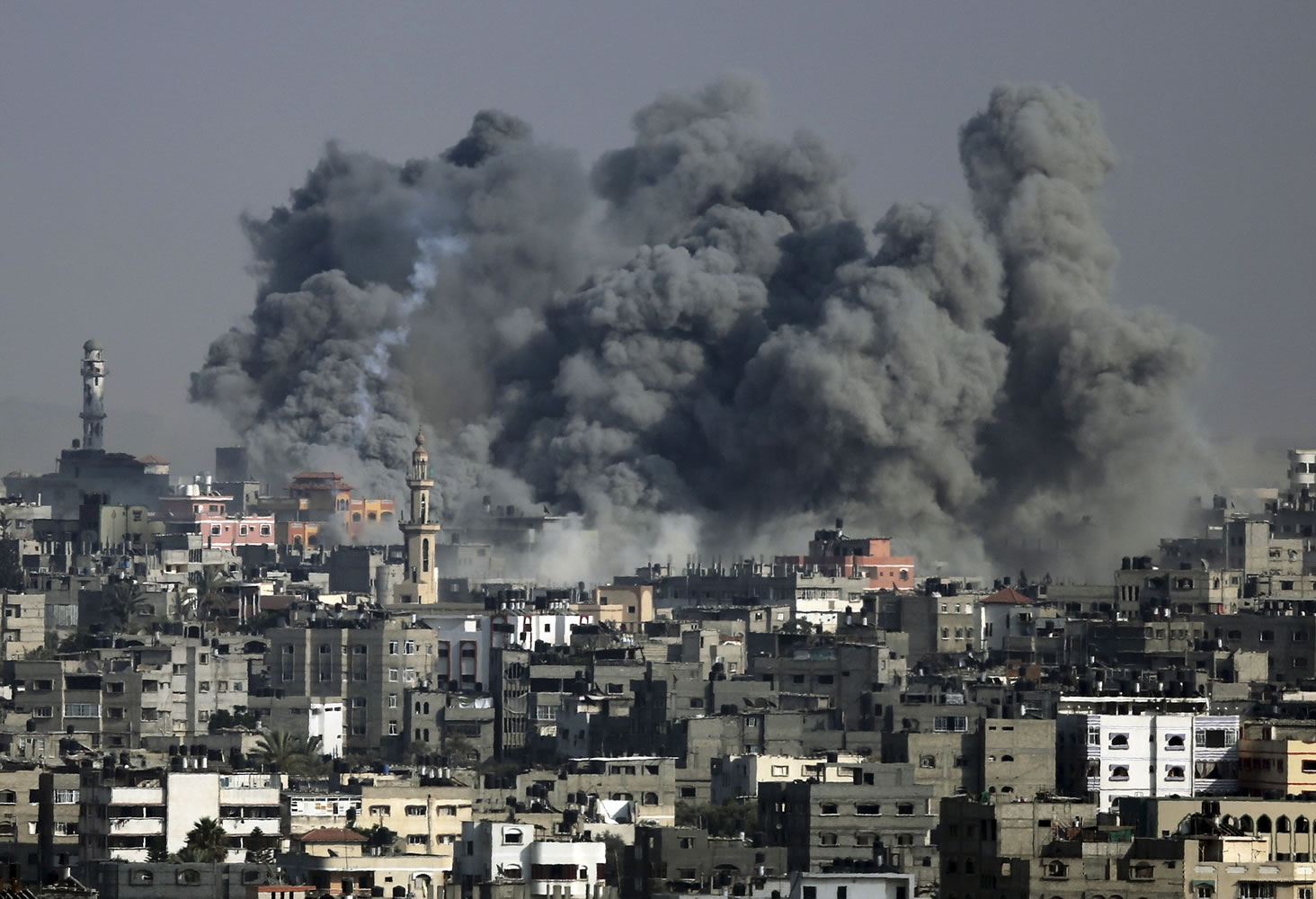 Smoke from an Israeli strike rises over Gaza City, Tuesday. Israeli airstrikes hit a wide range of locations along the coastal area of the Gaza Strip as diplomatic efforts intensified to end the two week war that has killed hundreds of Palestinians and dozens of Israelis.